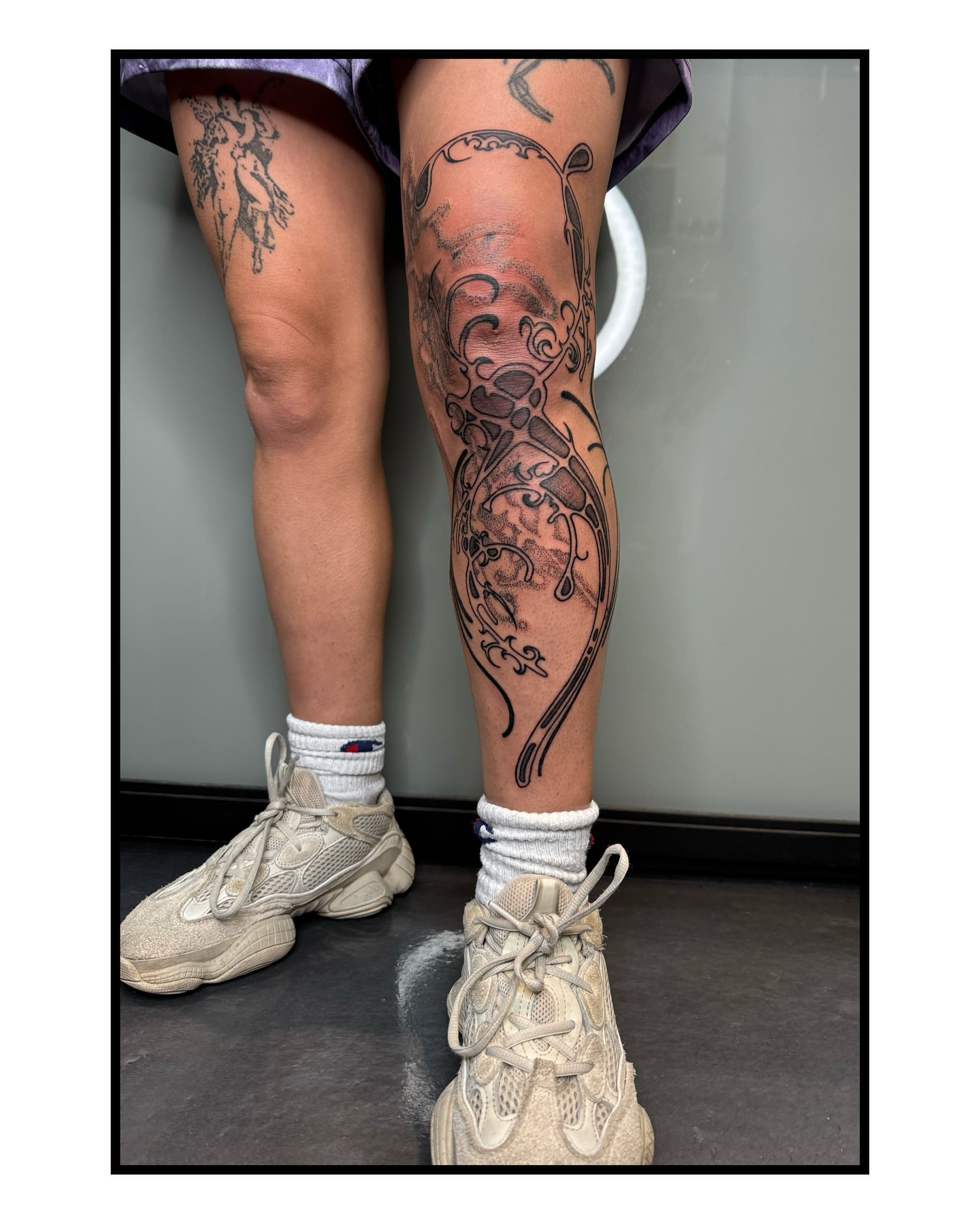 Floral design black and grey tattoo on the calf by Milo
