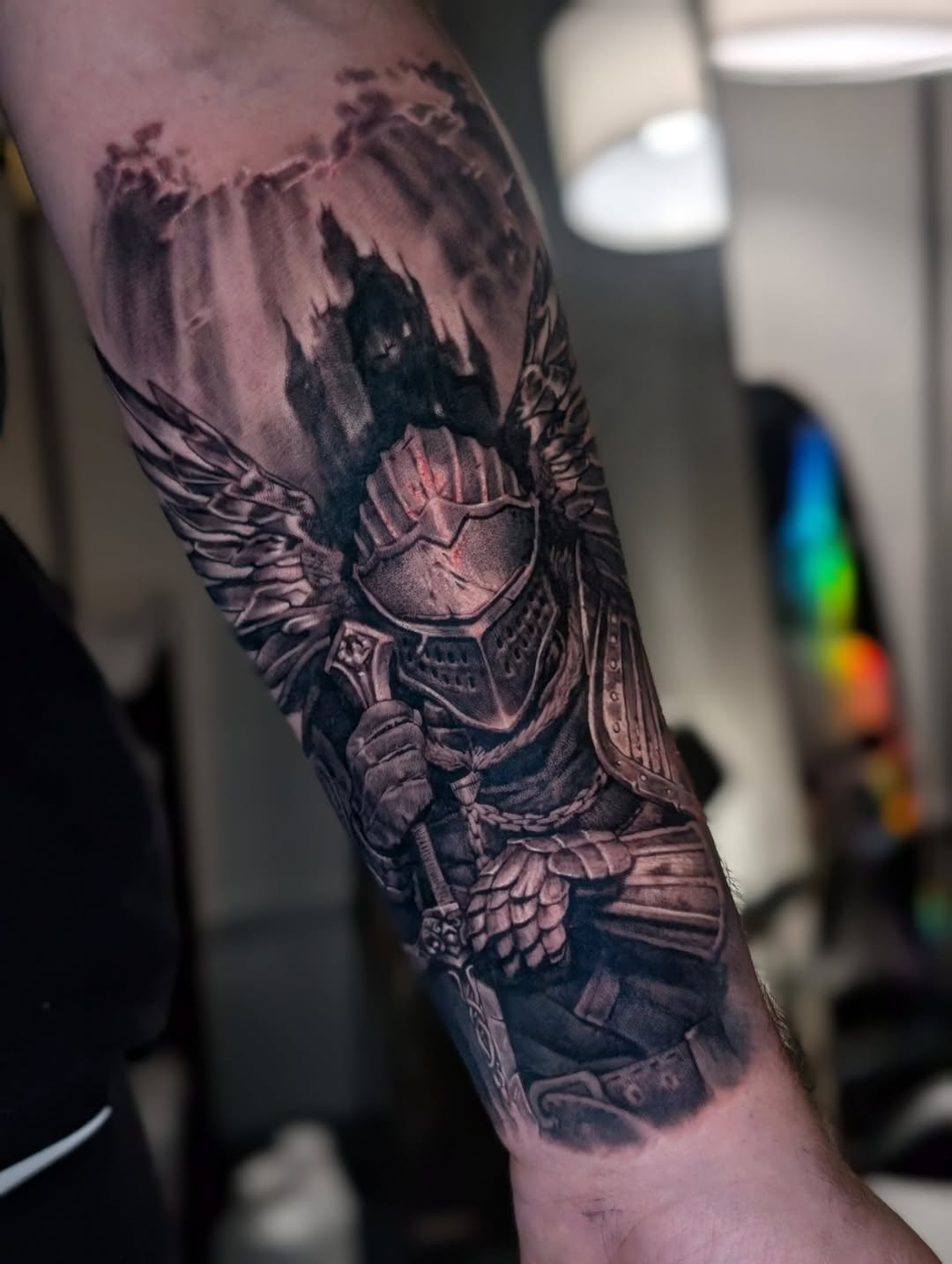 Armored knight with wings and castle realism tattoo on the forearm by Miami Florida Tattoo Artist