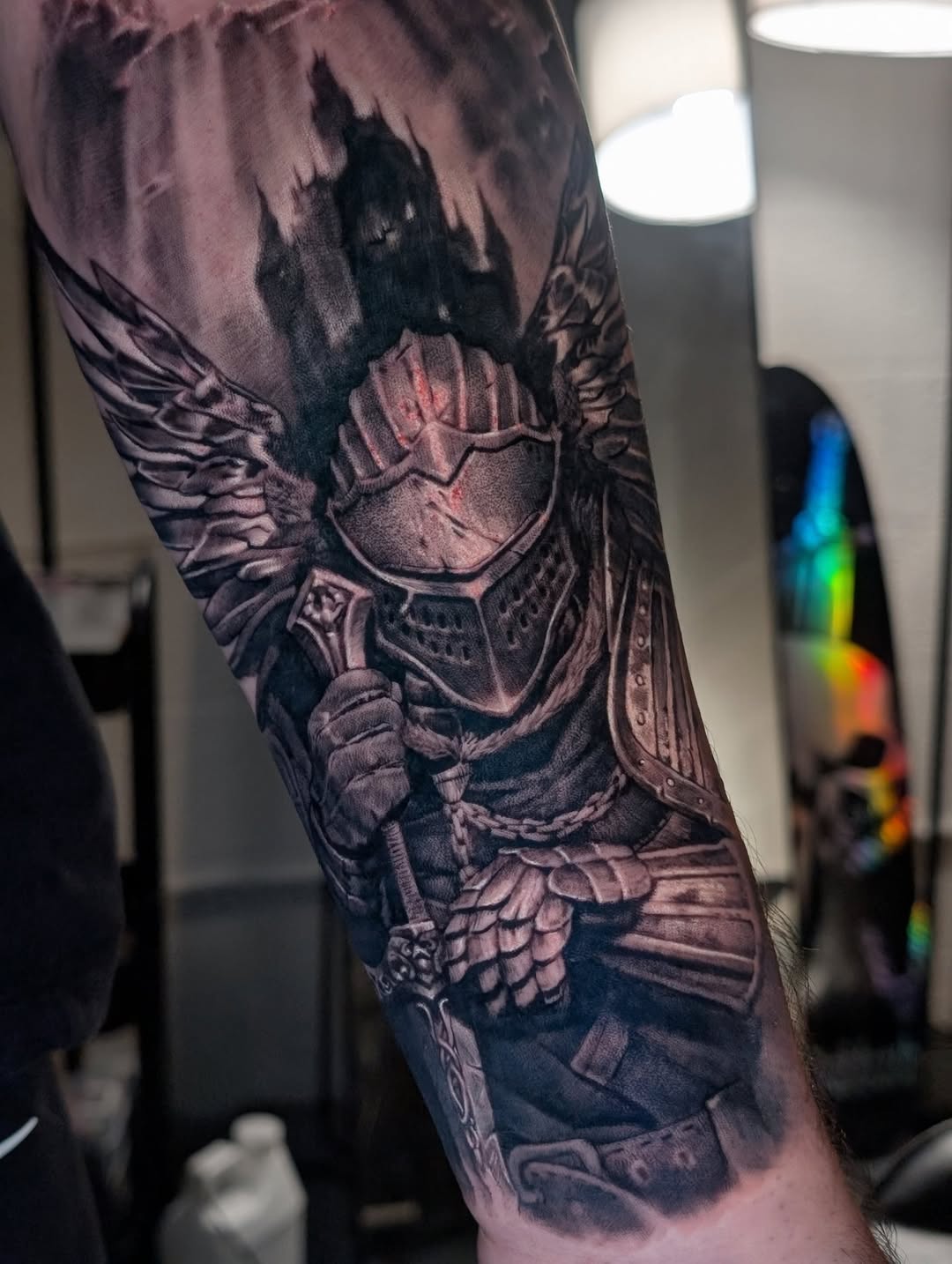 Armored knight with wings and castle realism tattoo on the forearm by Miami Florida Tattoo Artist