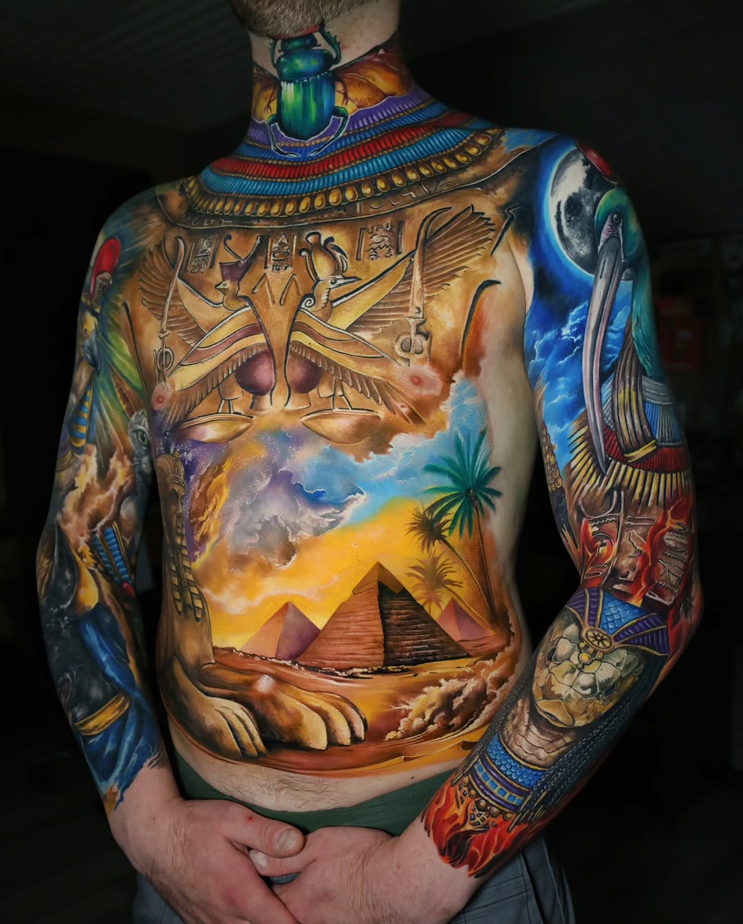 Egyptian landscape with pyramids and deities Japanese tattoo on the torso by Marek Pawlik