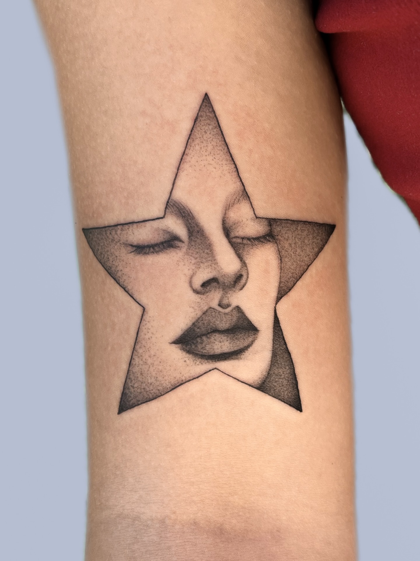 Abstract face dotwork tattoo on the forearm by nina