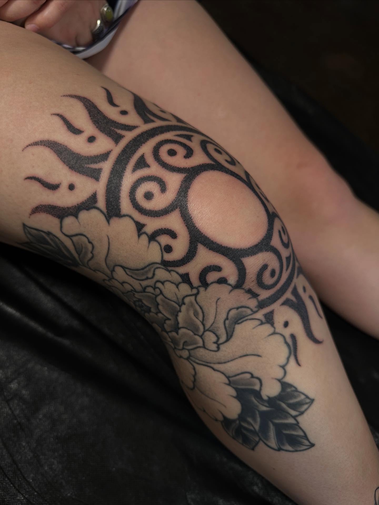 Sun and floral tribal tattoo on the thigh by Owlyn Madrone