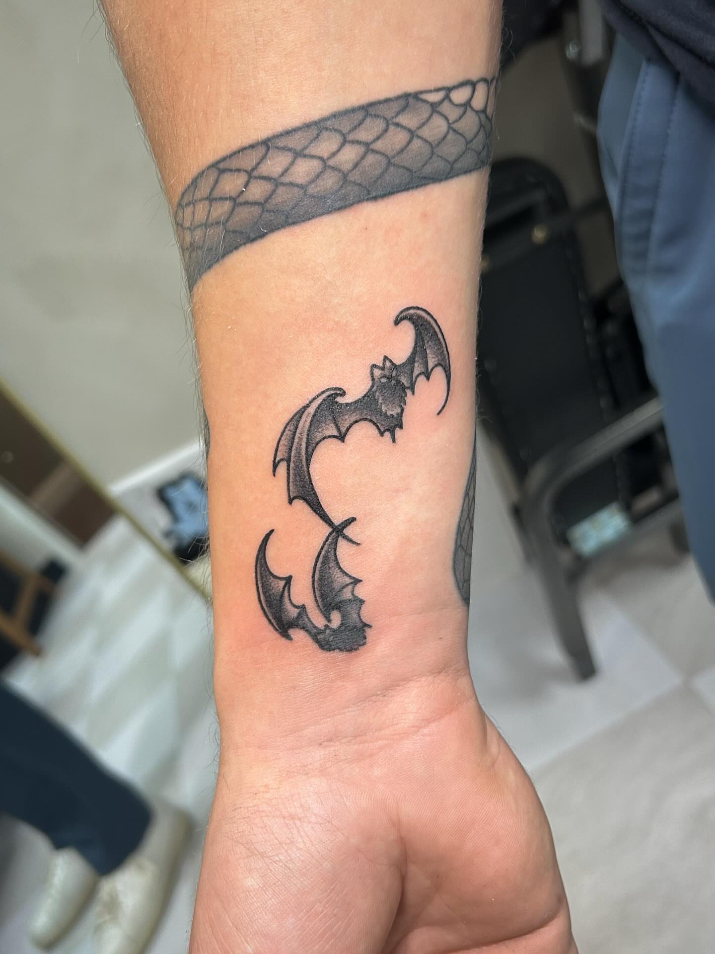 Bat black and grey tattoo on the forearm by kuna ink