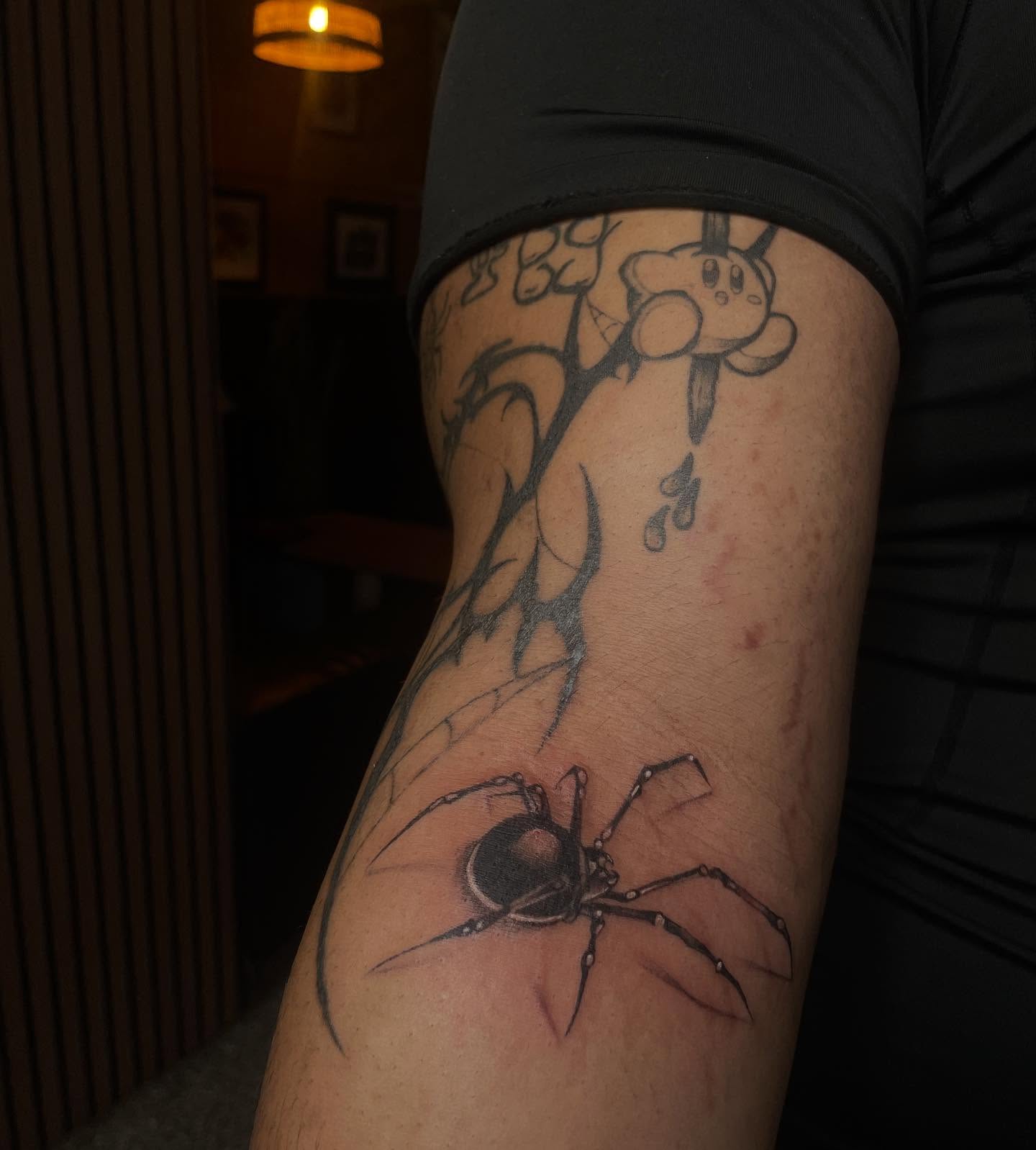 Spider and cartoon character realism tattoo on the forearm by Trinity