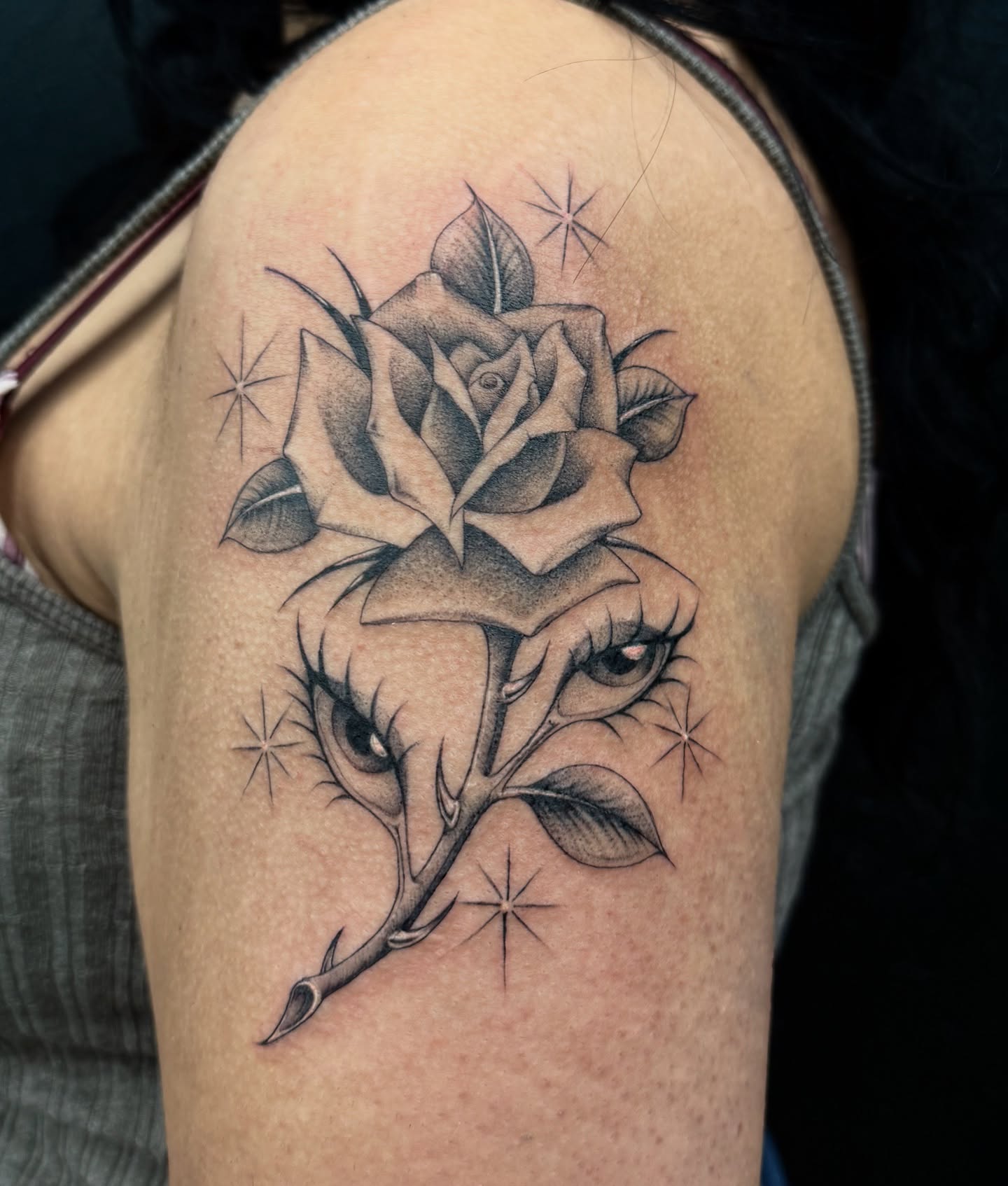Rose with eyes realism tattoo on the shoulder by dinah