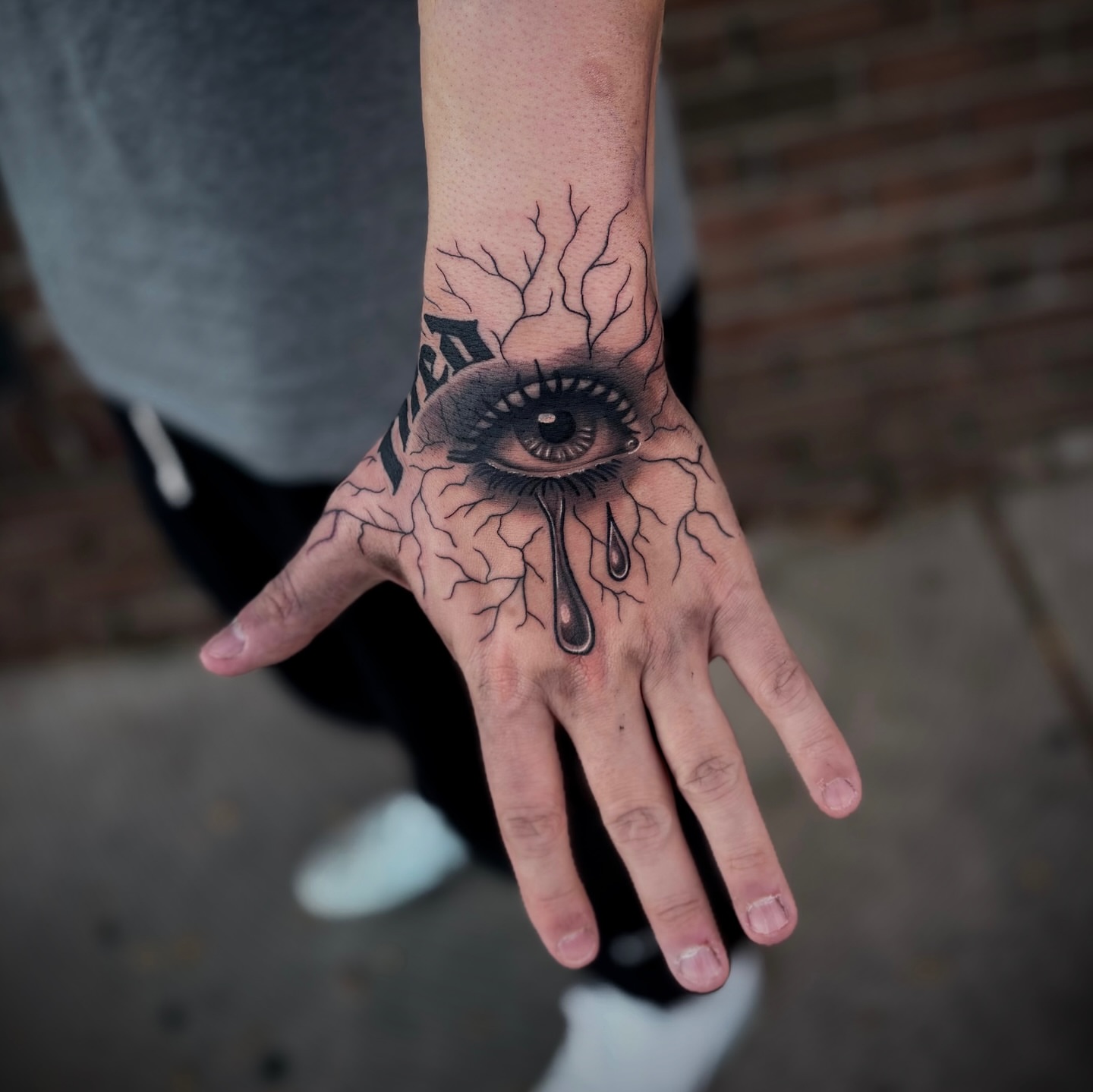 Eye with branches dark realism tattoo on the hand by Lauren Dempsey, Dearborn, Michigan