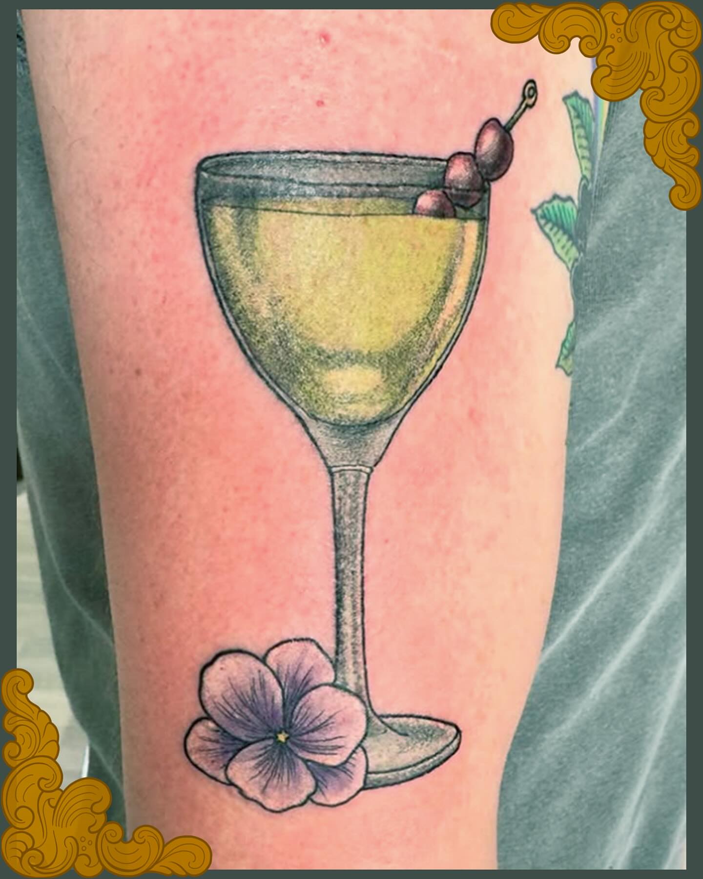 Martini glass with olives realism tattoo on the forearm by Patrick Carroll
