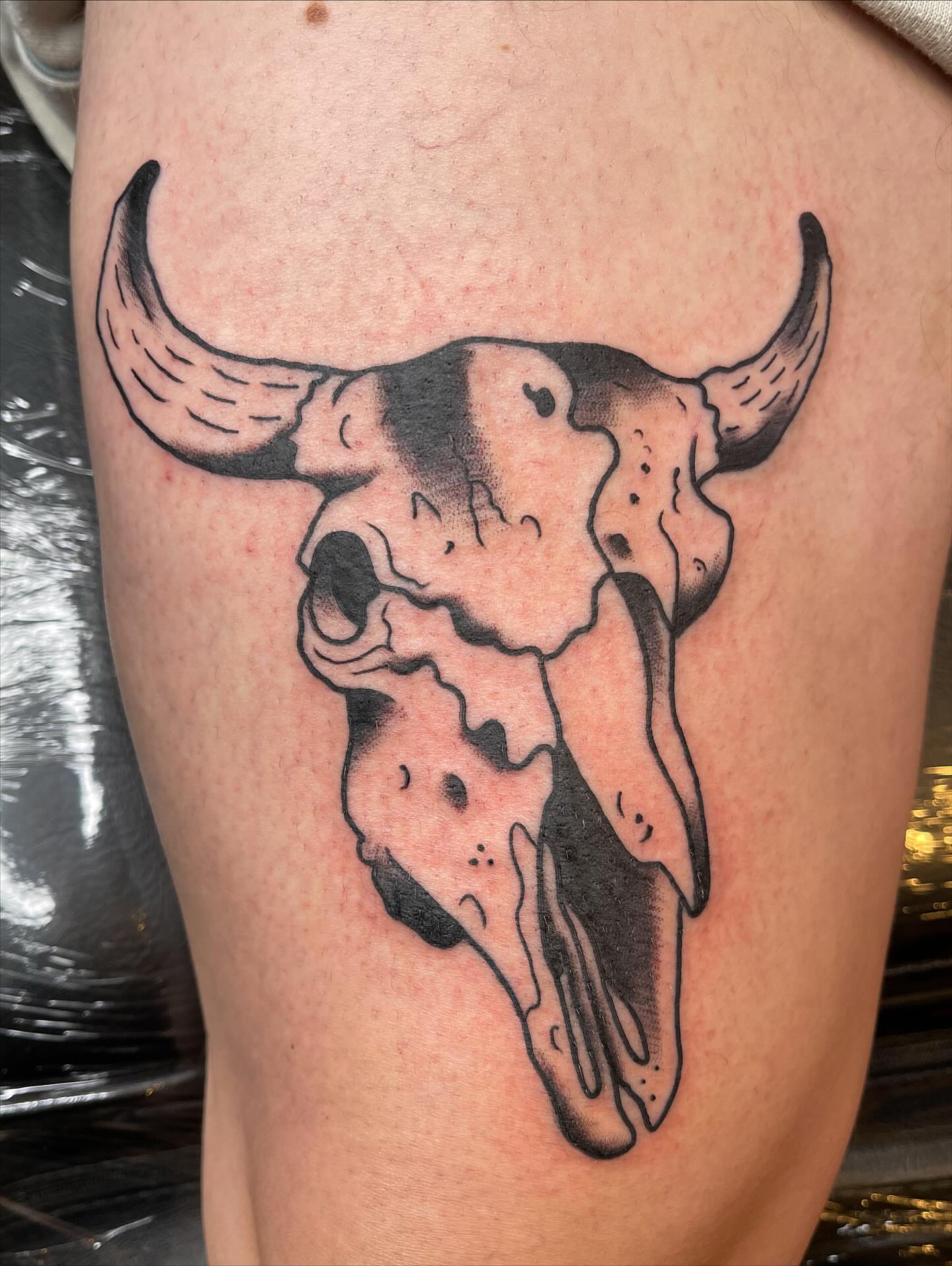 Bull skull black and grey tattoo on the thigh by Josh Brownell