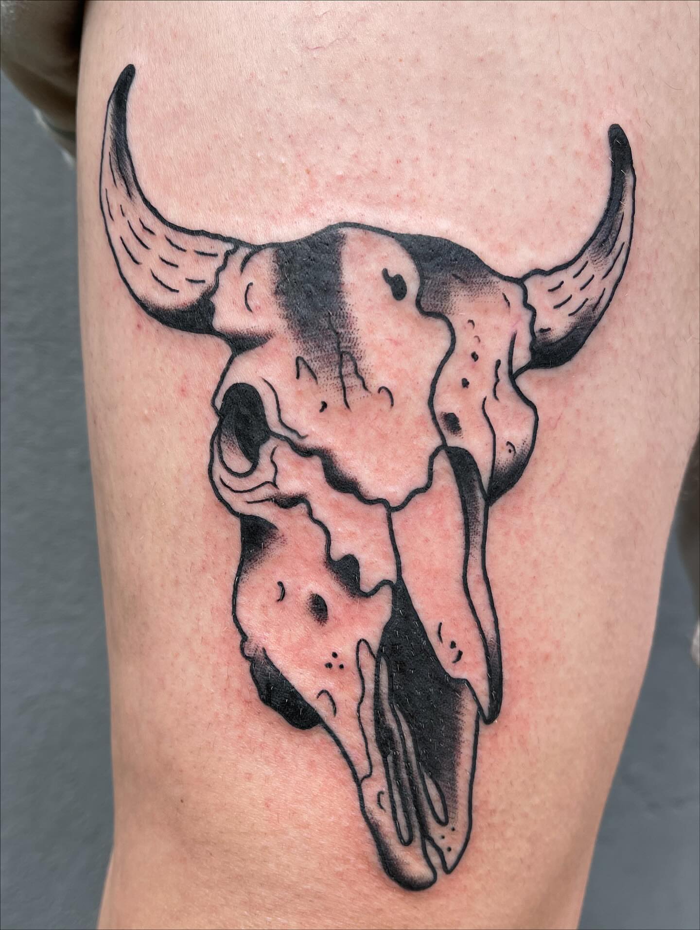 Bull skull black and grey tattoo on the thigh by Josh Brownell