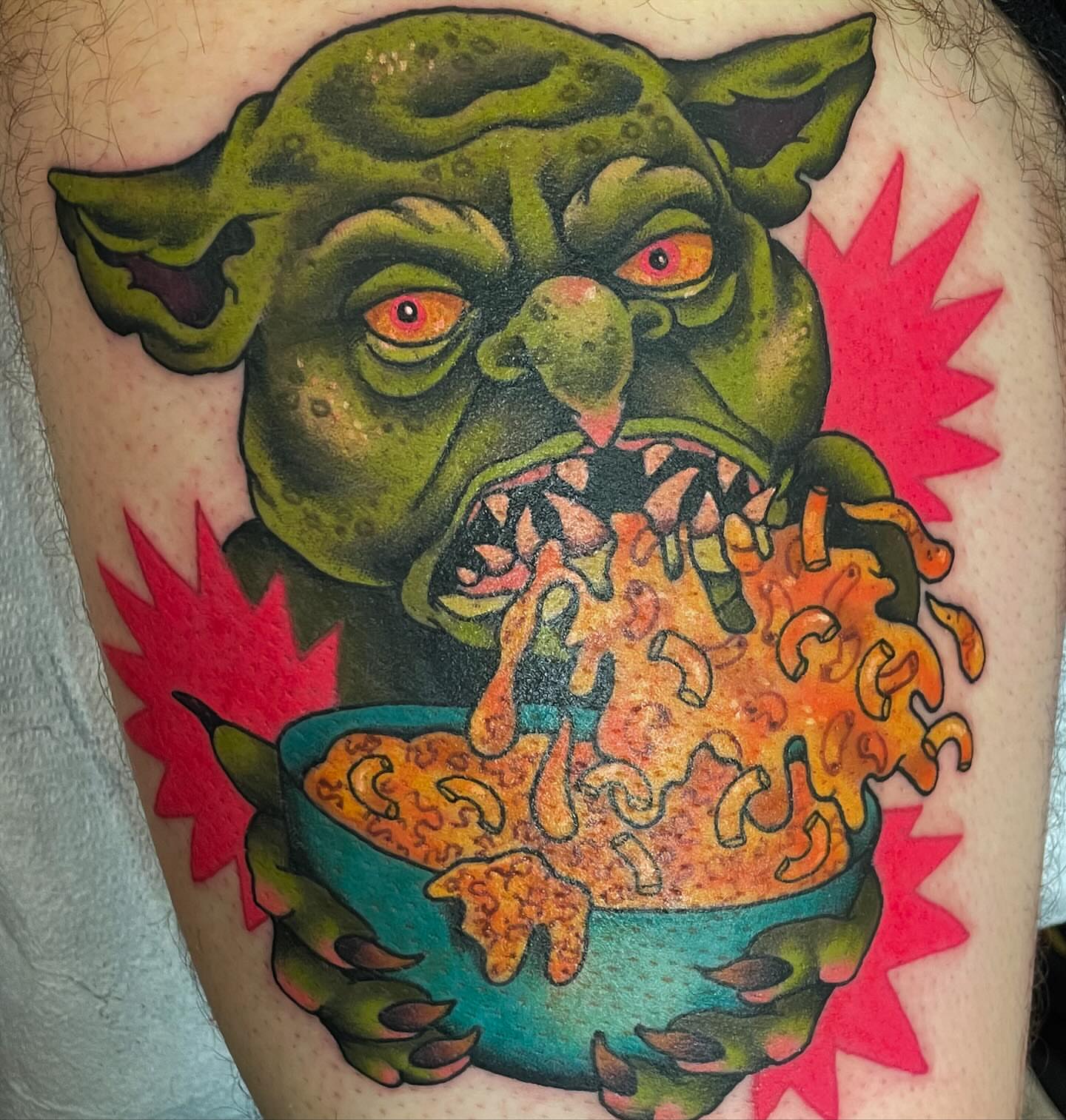 Green monster eating cereal American traditional tattoo on the thigh by Monica Amneus