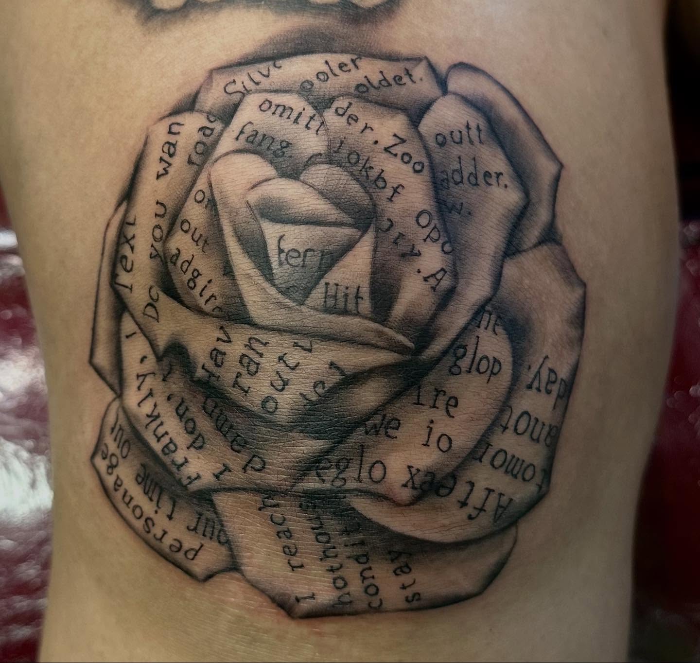 Rose with text black and grey tattoo on the forearm by Alan