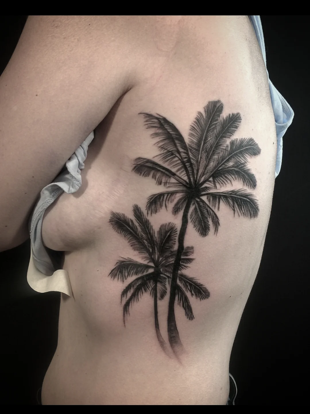 Palm trees black and grey tattoo on the ribs by Ashton Allen-Ruiz, Portland, Oregon