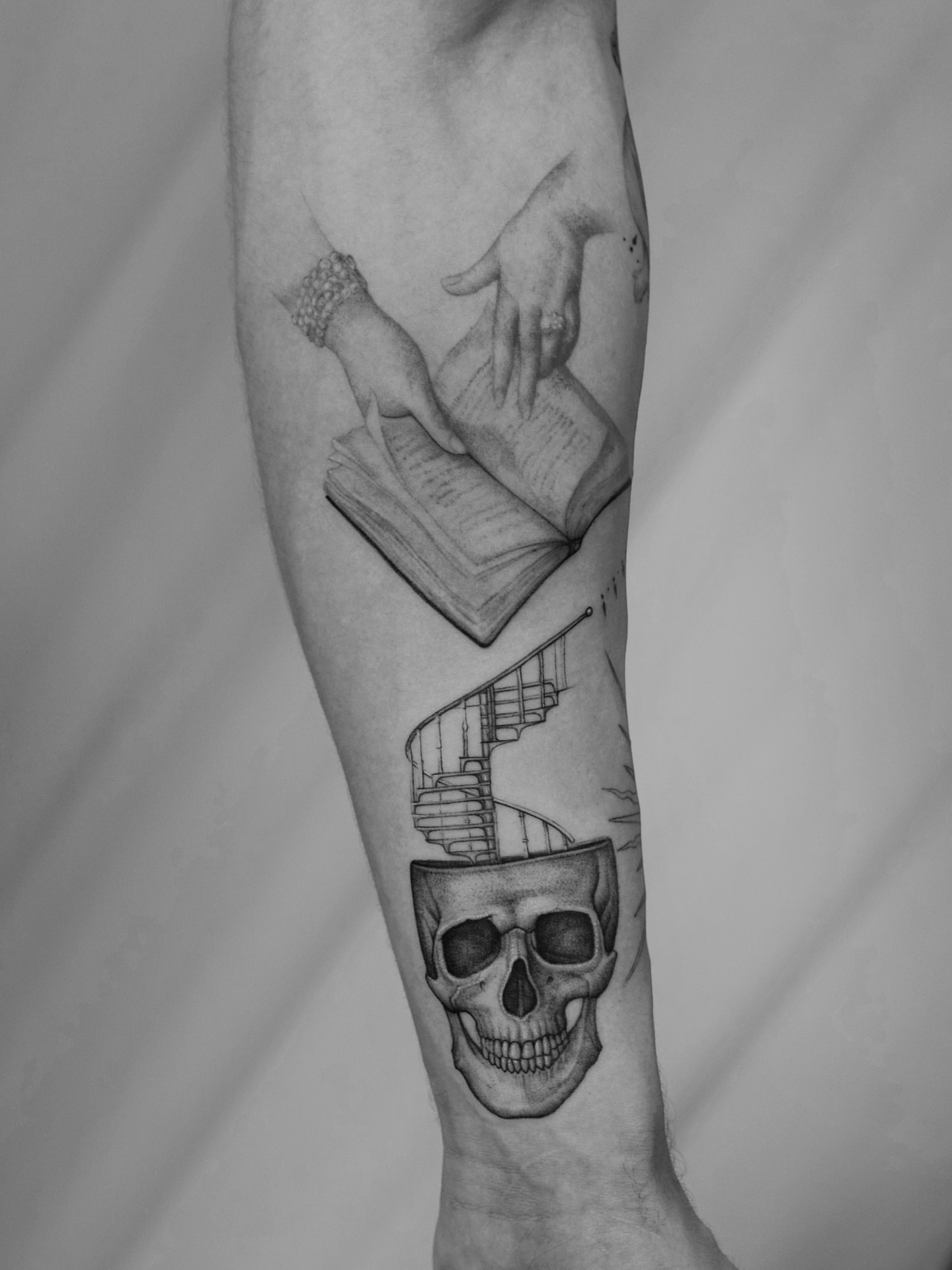 Book and skull realism tattoo on the forearm by Ray Quinday
