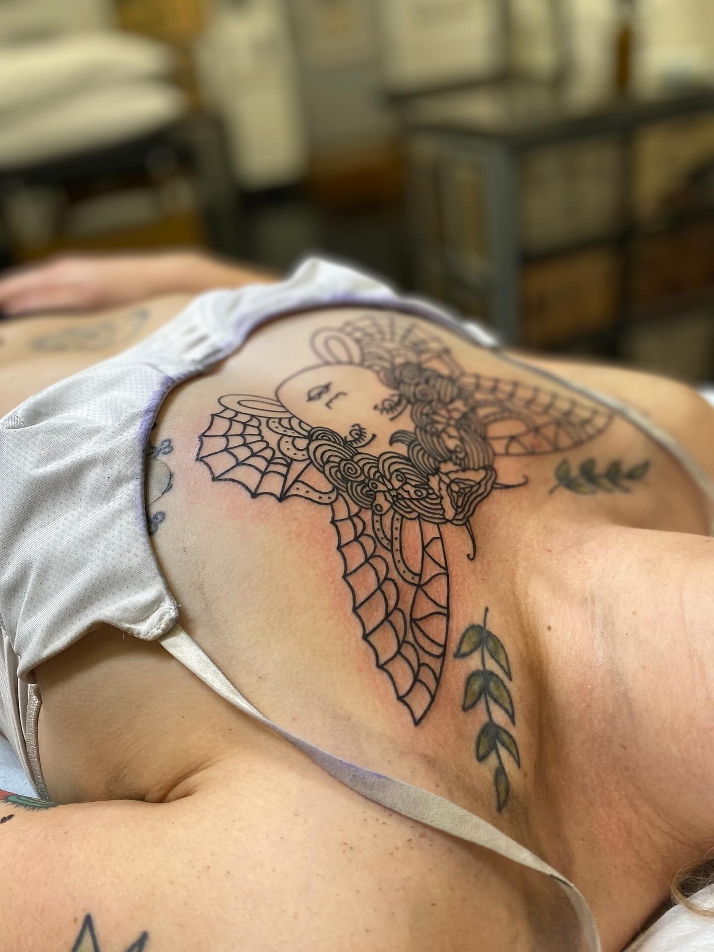 Woman with wings neo-traditional tattoo on the chest by @rubber_band_dan, San Francisco, California
