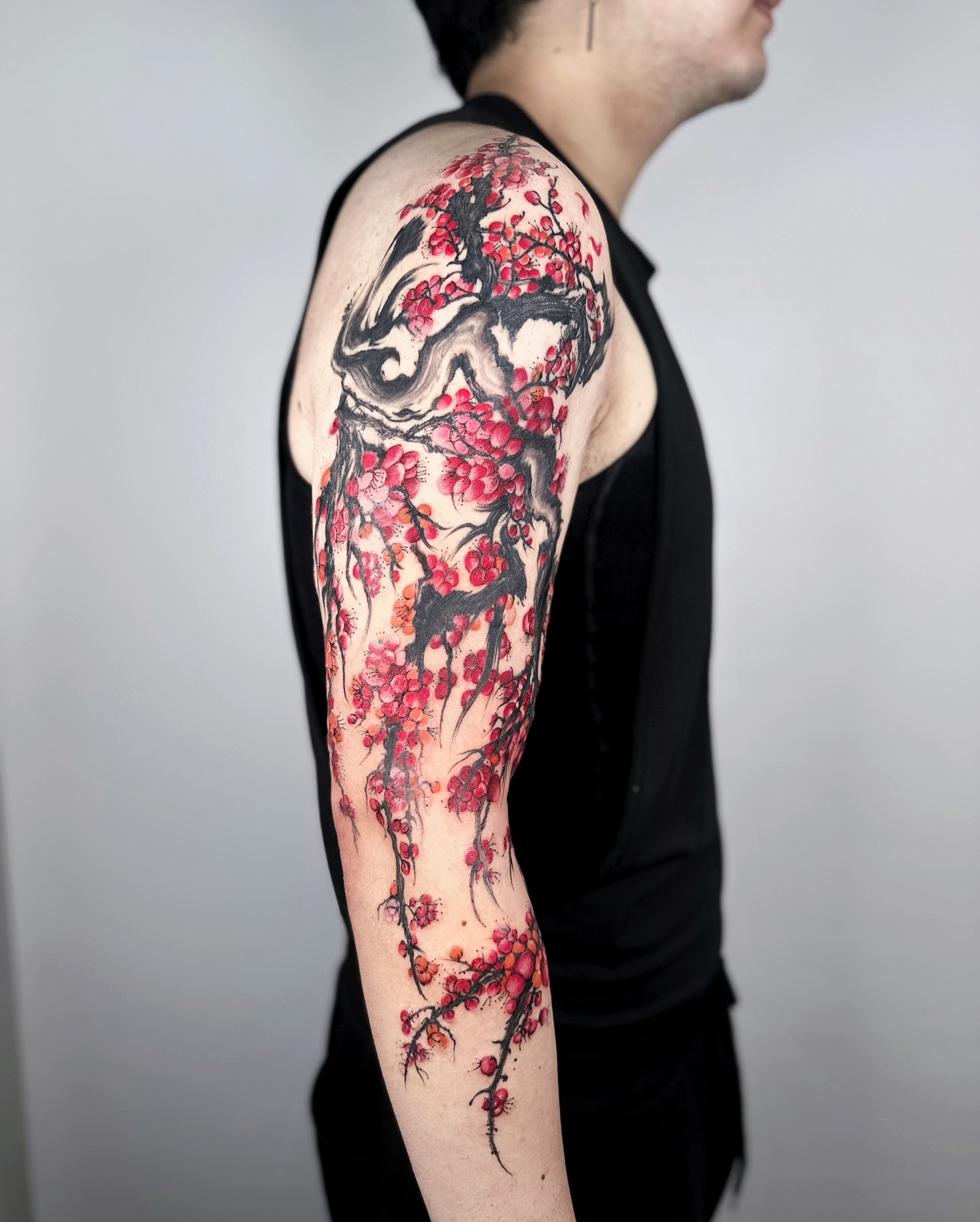 Cherry blossom tree watercolor tattoo on the upper arm by Jiang_Tattooer