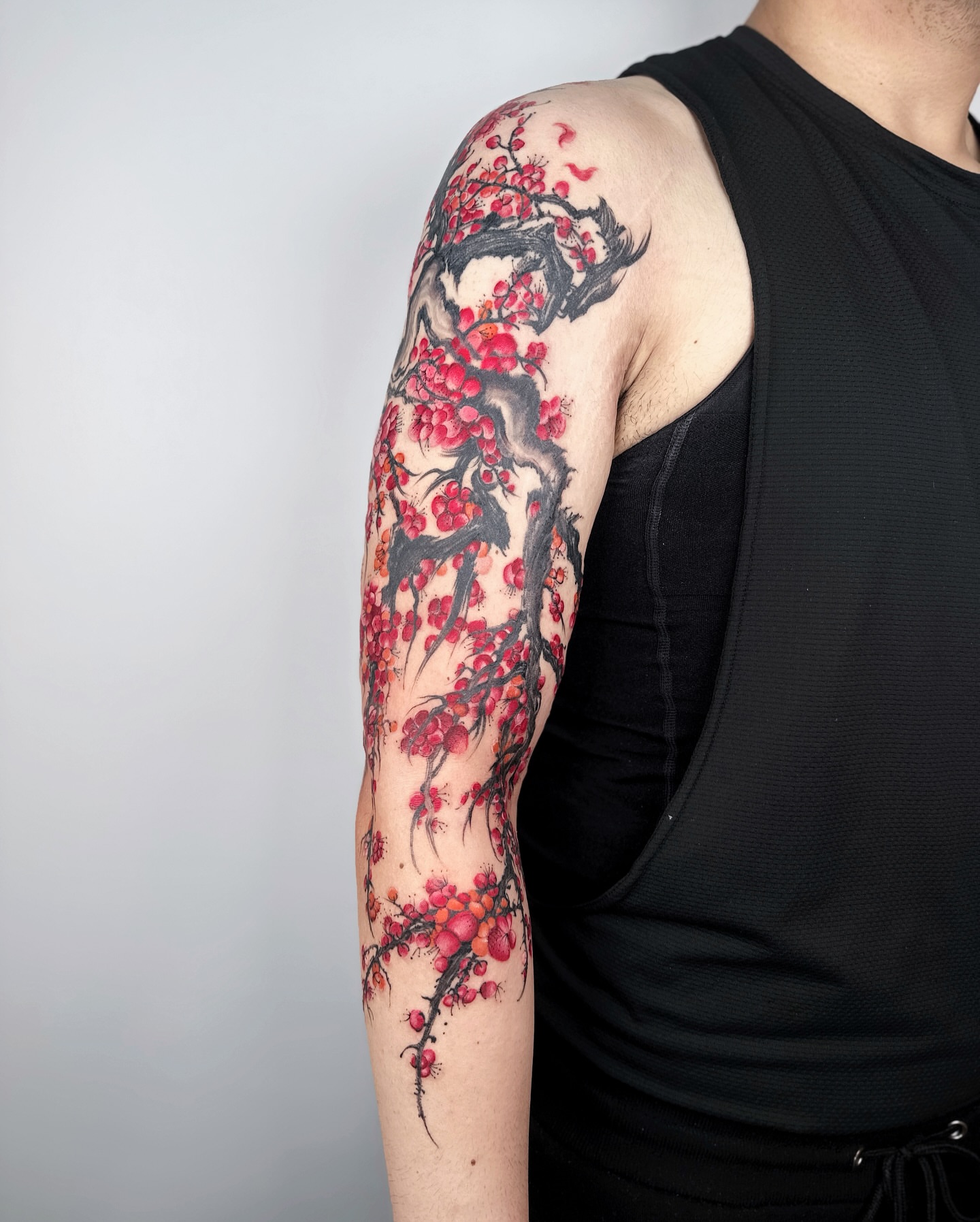 Cherry blossom and bird japanese irezumi tattoo on the upper arm by Jiang_Tattooer