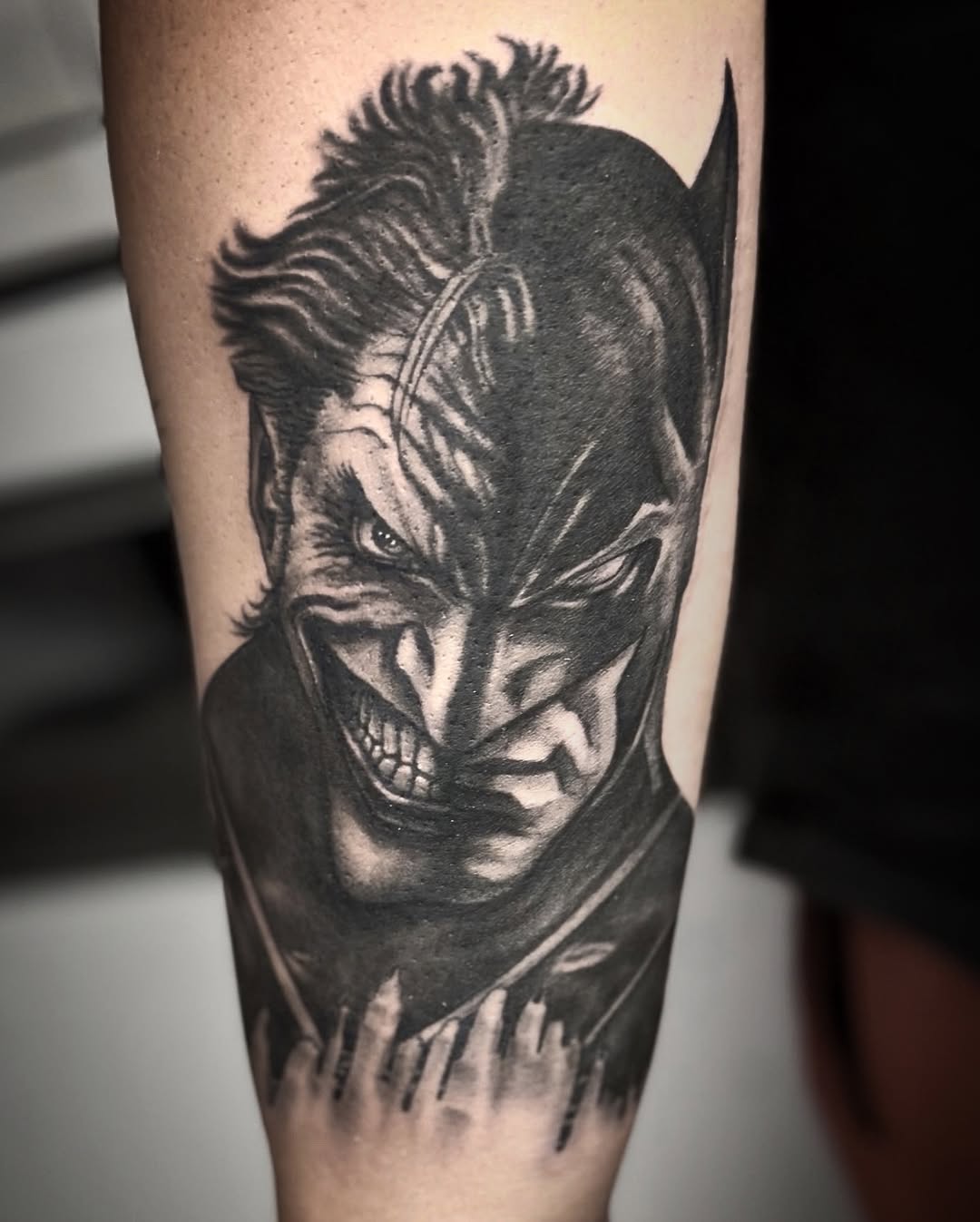Joker and Batman mashup portrait realism tattoo on the forearm by Juan c munoz jr, Chicago, Illinois