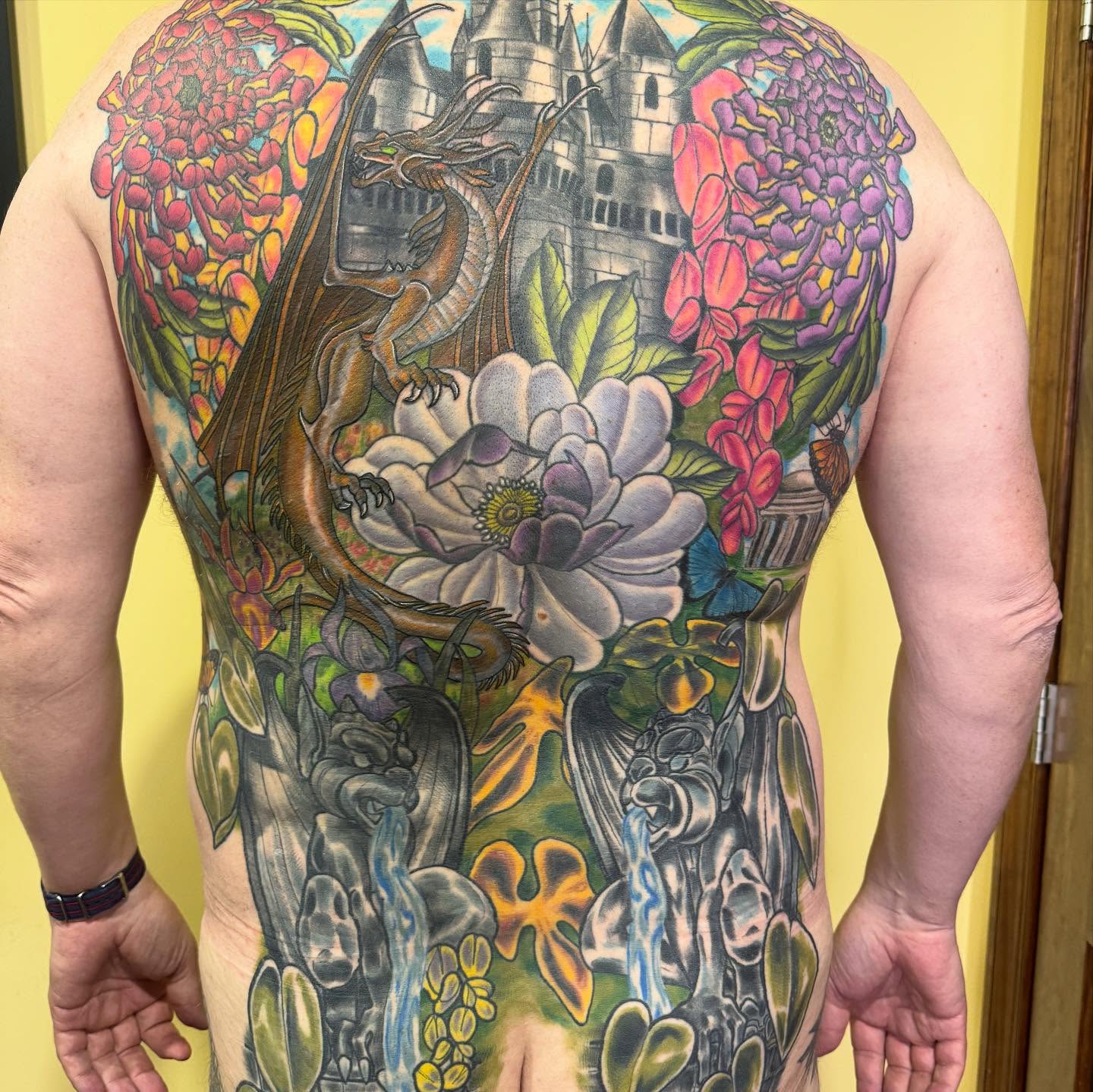 Dragon and floral illustrative tattoo on the back by Erin McDavis
