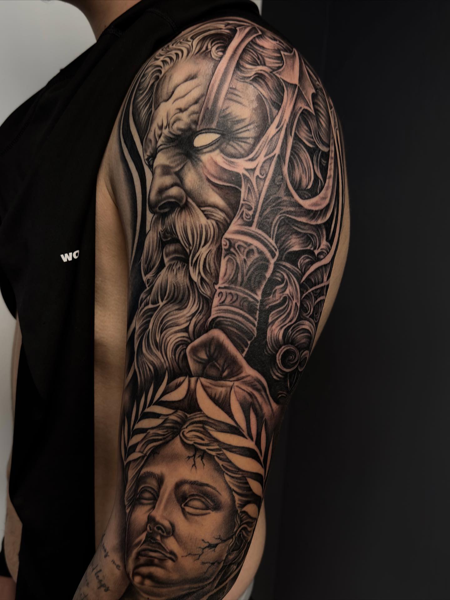 Ancient warrior and woman realism tattoo on the upper arm by Hugo Ruiz-Esparza