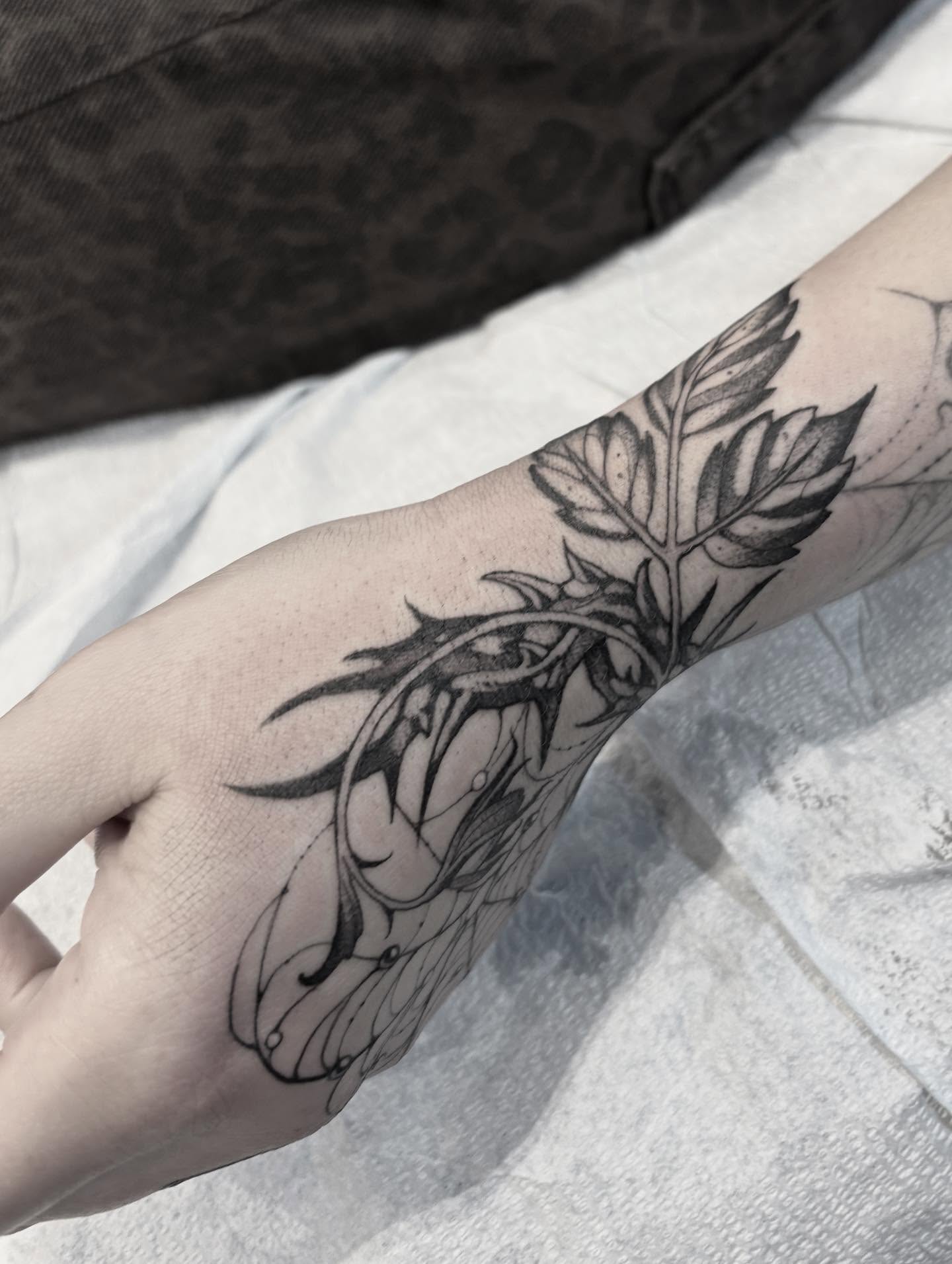 Dragon and leaves realism tattoo on the forearm by Becci Chelicerata