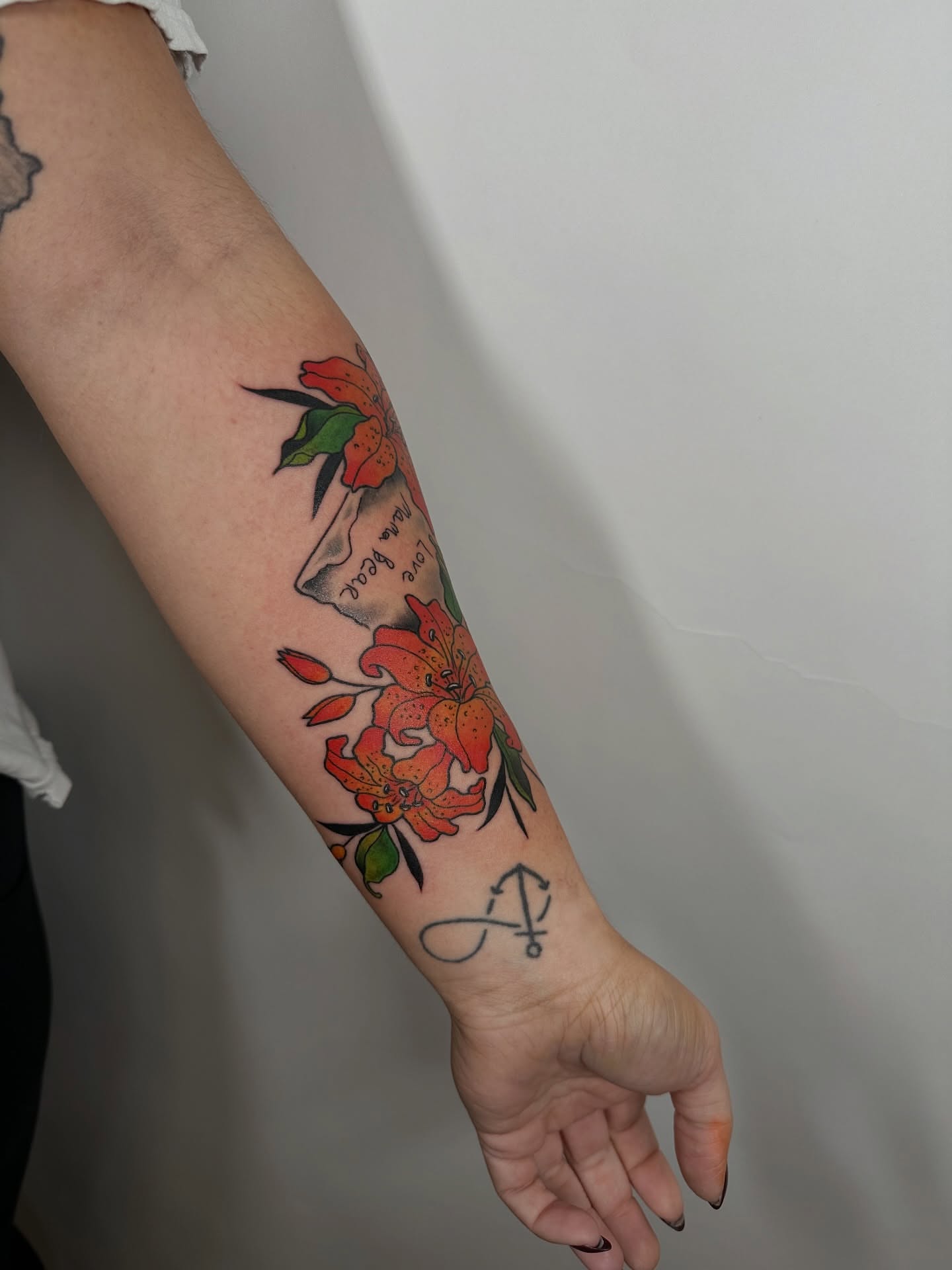 Floral arrangement American traditional tattoo on the forearm by Heather Cherish