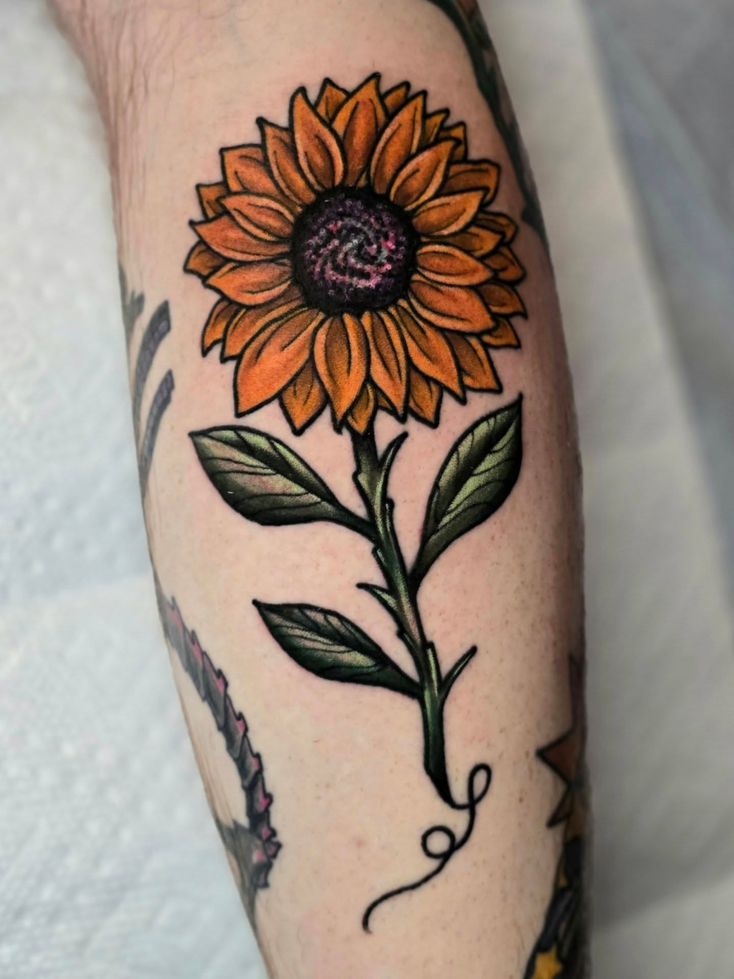 Sunflower American traditional tattoo on the forearm by Adison Essig