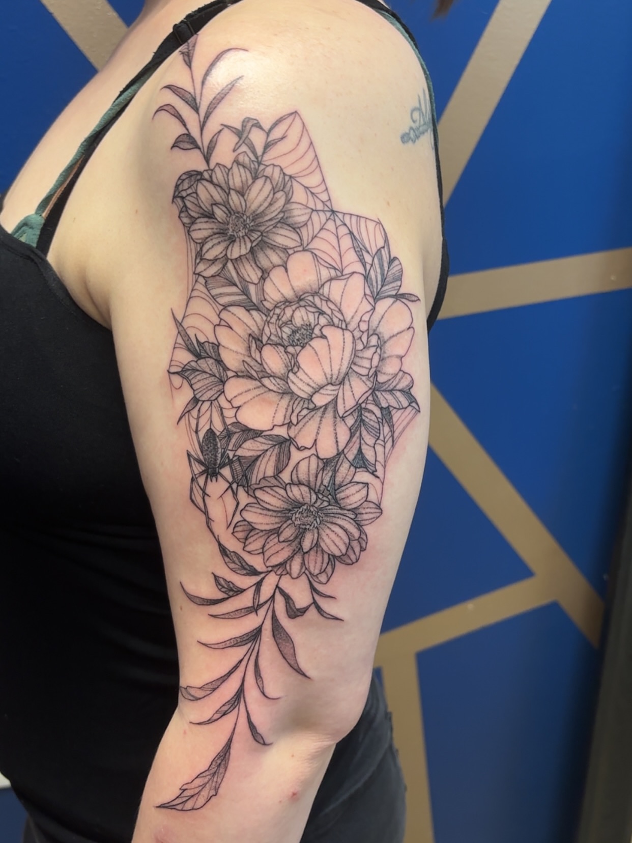Floral bouquet black and grey tattoo on the upper arm by ✨Cyerra Lynne✨