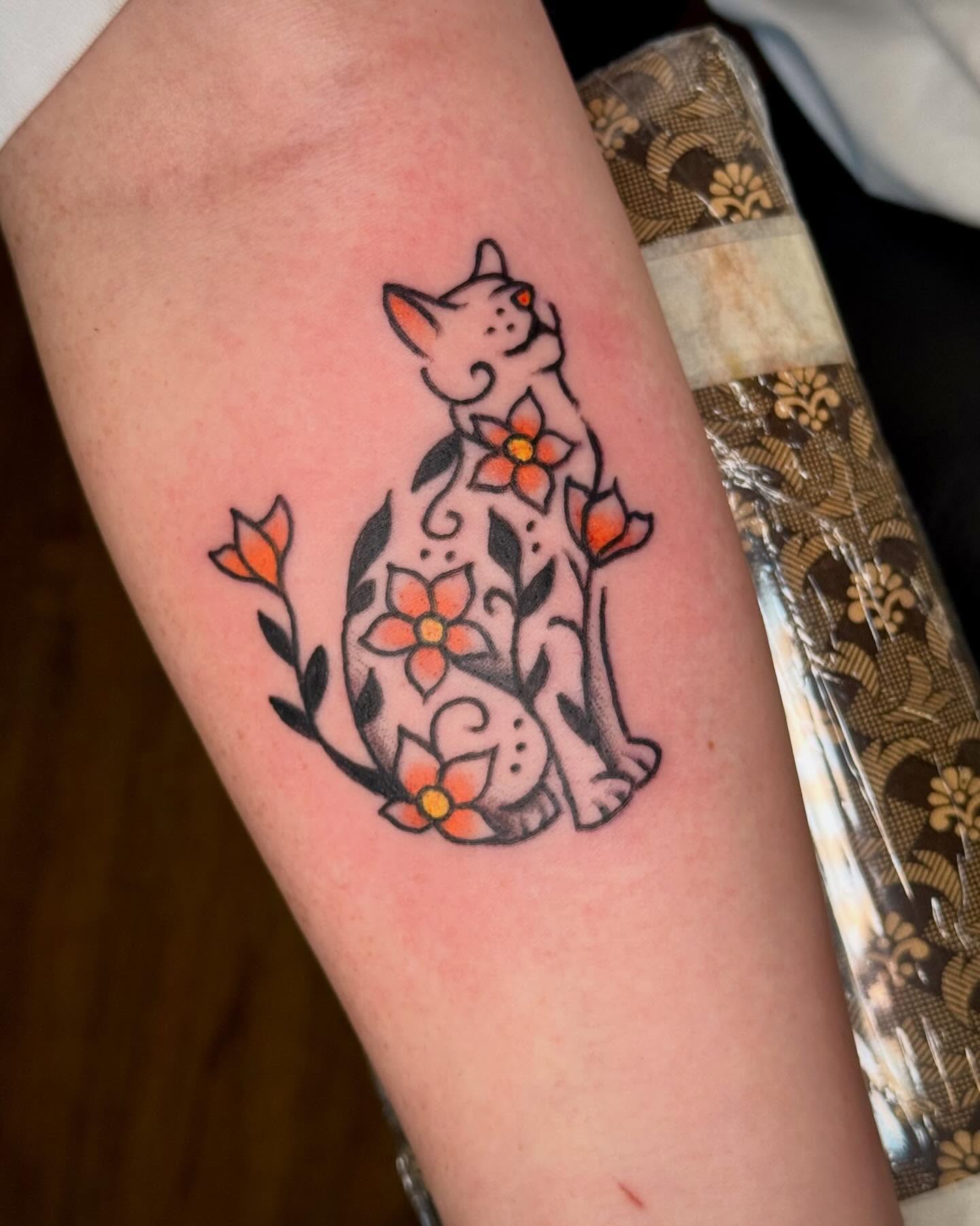 Cat and flowers new school tattoo on the forearm by Ty Elias