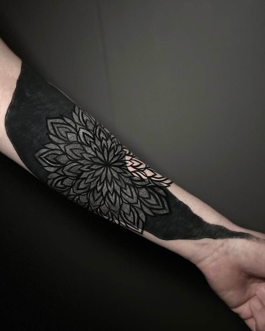 Mandala black and grey tattoo on the forearm by Eric Hare