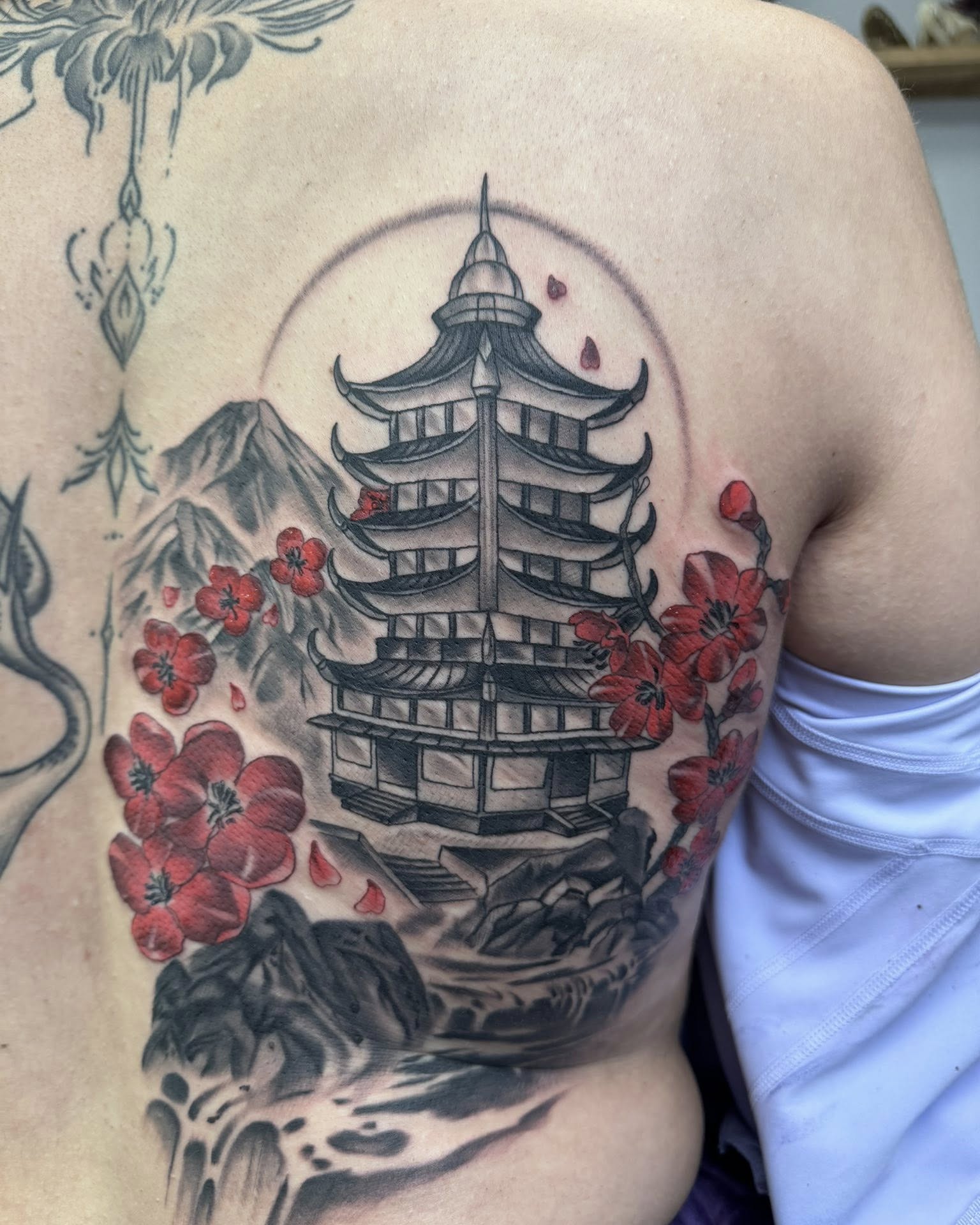 Pagoda and cherry blossoms japanese irezumi tattoo on the back by Murbee
