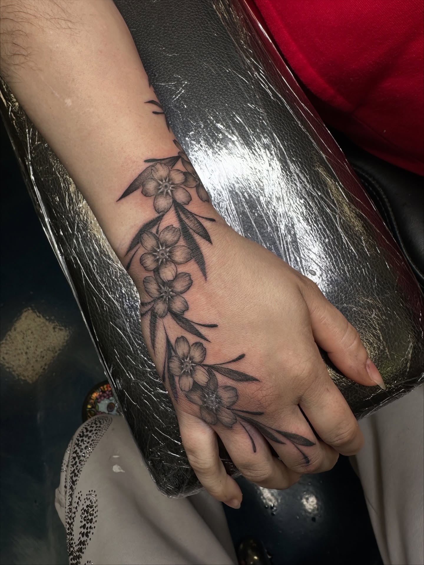 Cherry blossoms black and grey tattoo on the forearm by Sam Minneci