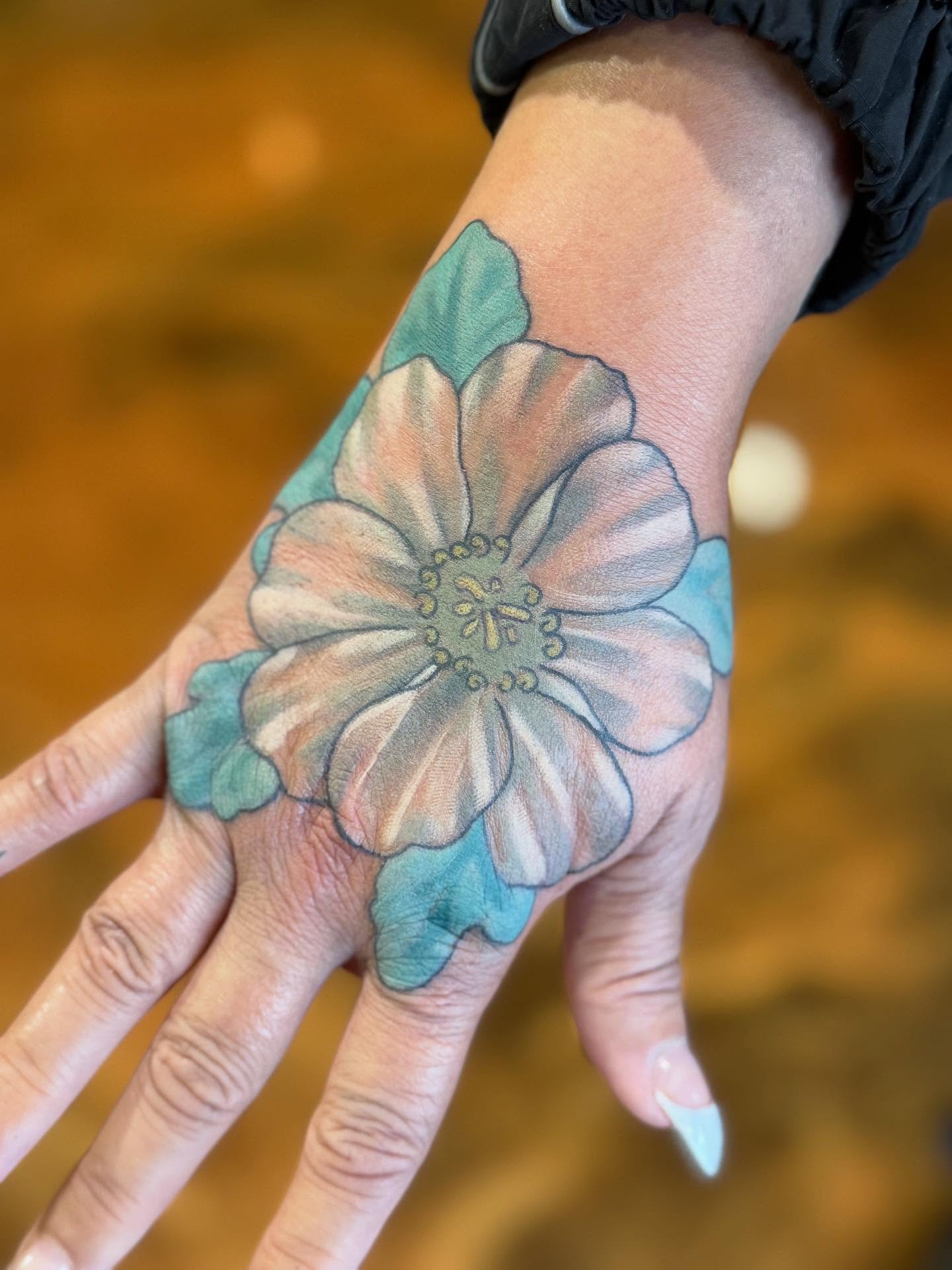 Flower realism tattoo on the hand by Erin McDavis