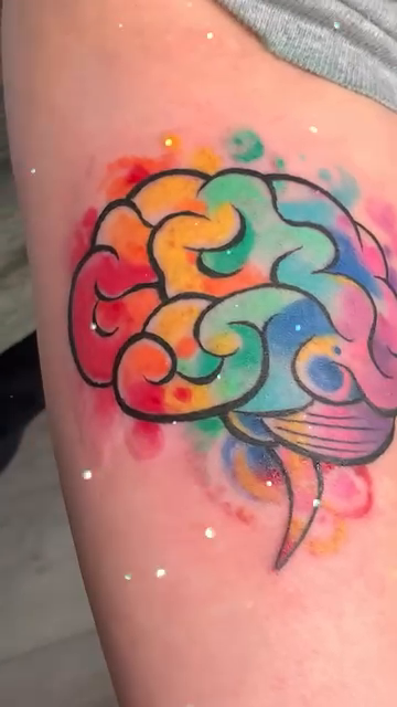 Colorful brain tattoo watercolor tattoo on the upper arm by @colorrobbie