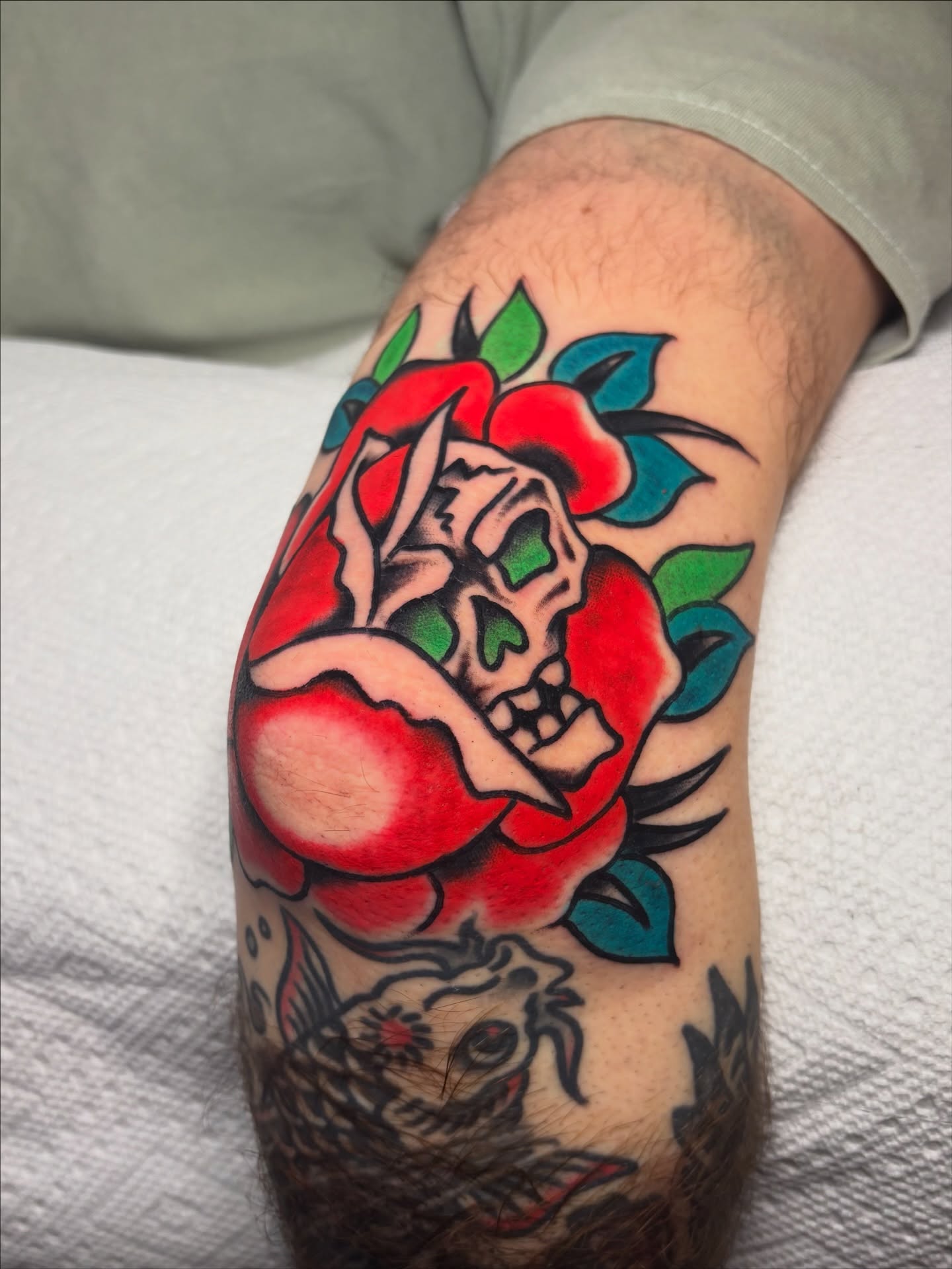 Rose with skull American traditional tattoo on the forearm by David Armacost, Cincinnati, Ohio
