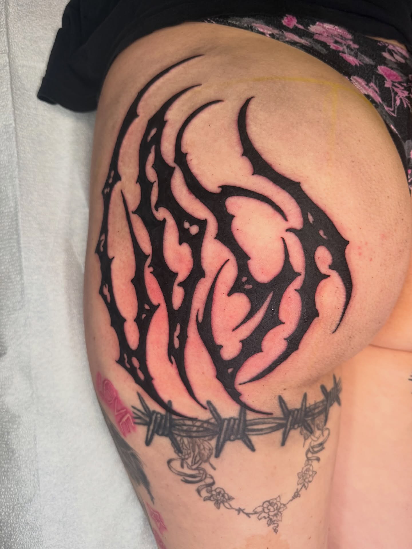 Barbed wire and flame tribal tattoo on the thigh by S C A B B e R W O C K y
