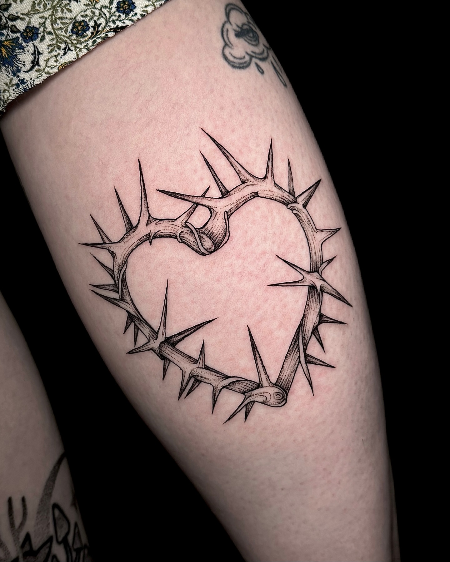 Crown of thorns black and grey tattoo on the thigh by Kam Mills