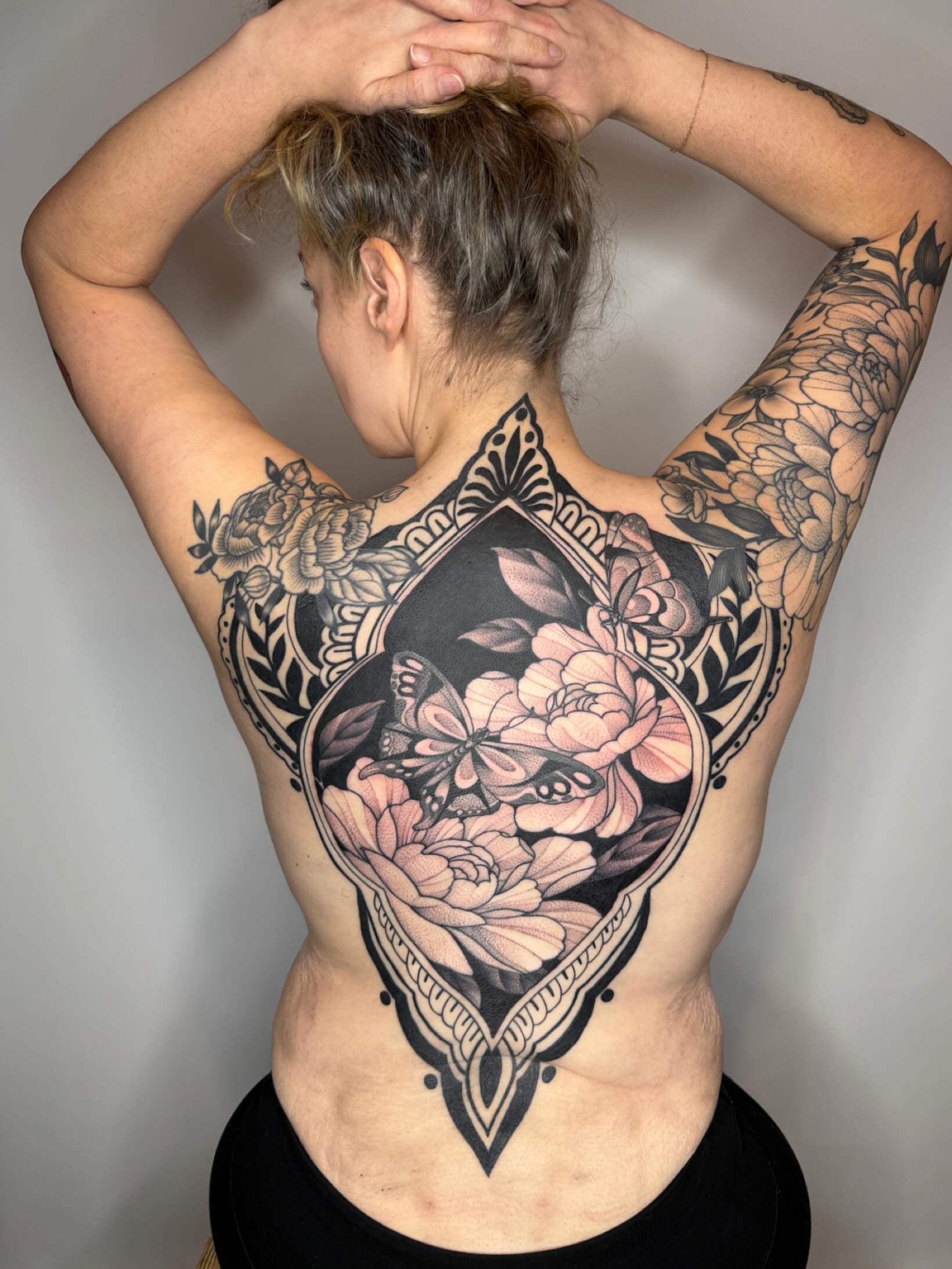 Floral bouquet American traditional tattoo on the back by Samantha Compasso Ford