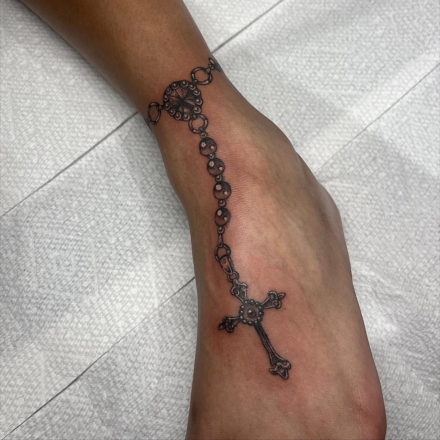 Rosary black and grey tattoo on the forearm by aurora