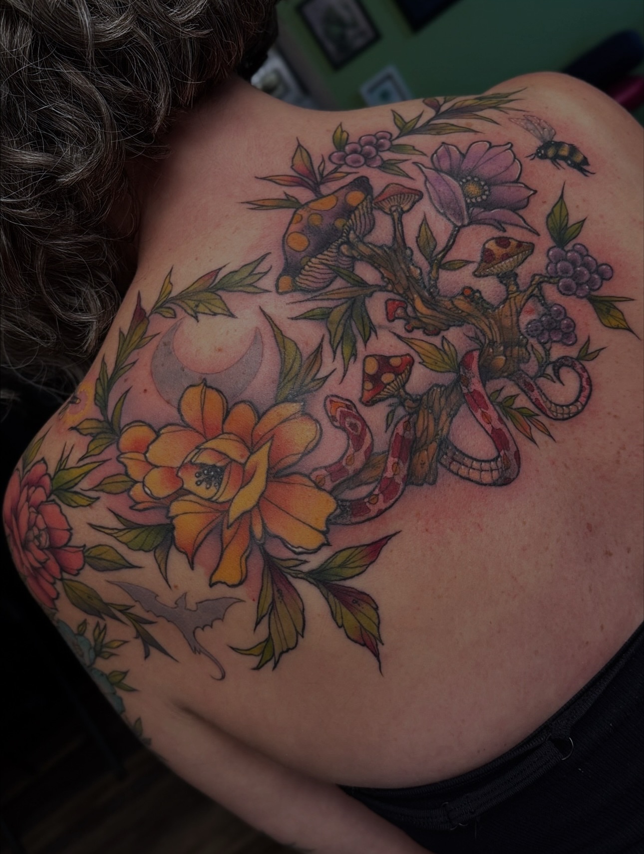 Floral and snake new school tattoo on the back by Michael Langdale