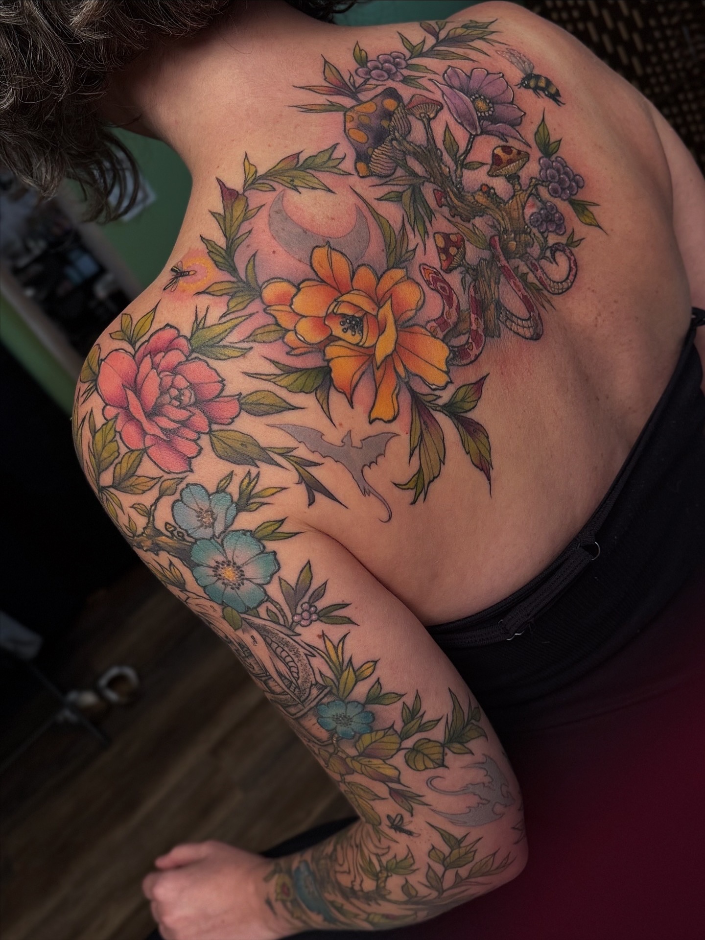 Floral bouquet American traditional tattoo on the back by Michael Langdale