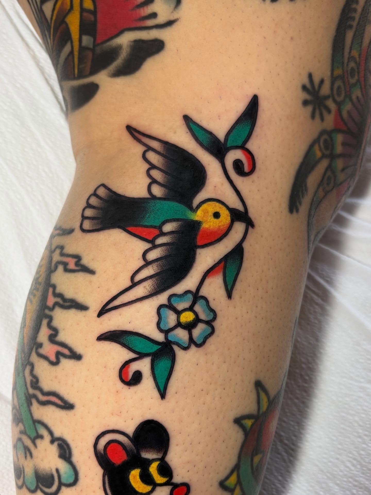 Bird and flower American traditional tattoo on the forearm by Traditional Tattooing