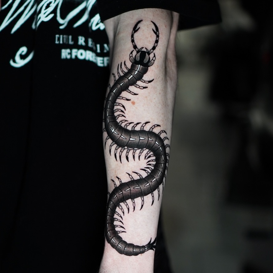 Centipede black and grey tattoo on the forearm by Jorden Ruppe