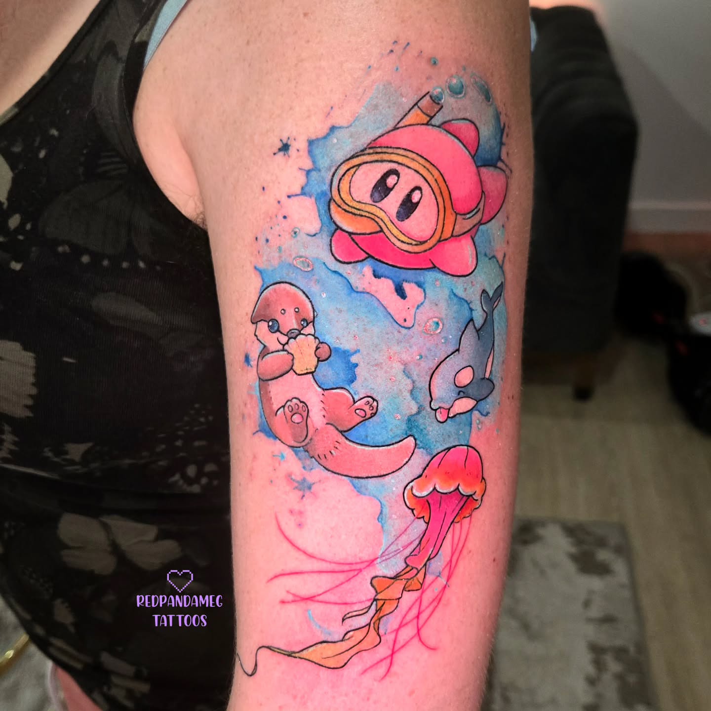 Underwater otter watercolor tattoo on the forearm by Meghan Hounsell