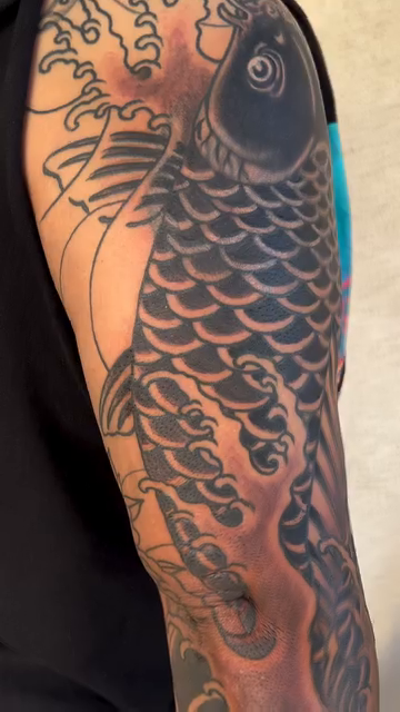Koi fish and waves japanese irezumi tattoo by Kayle Leogrande