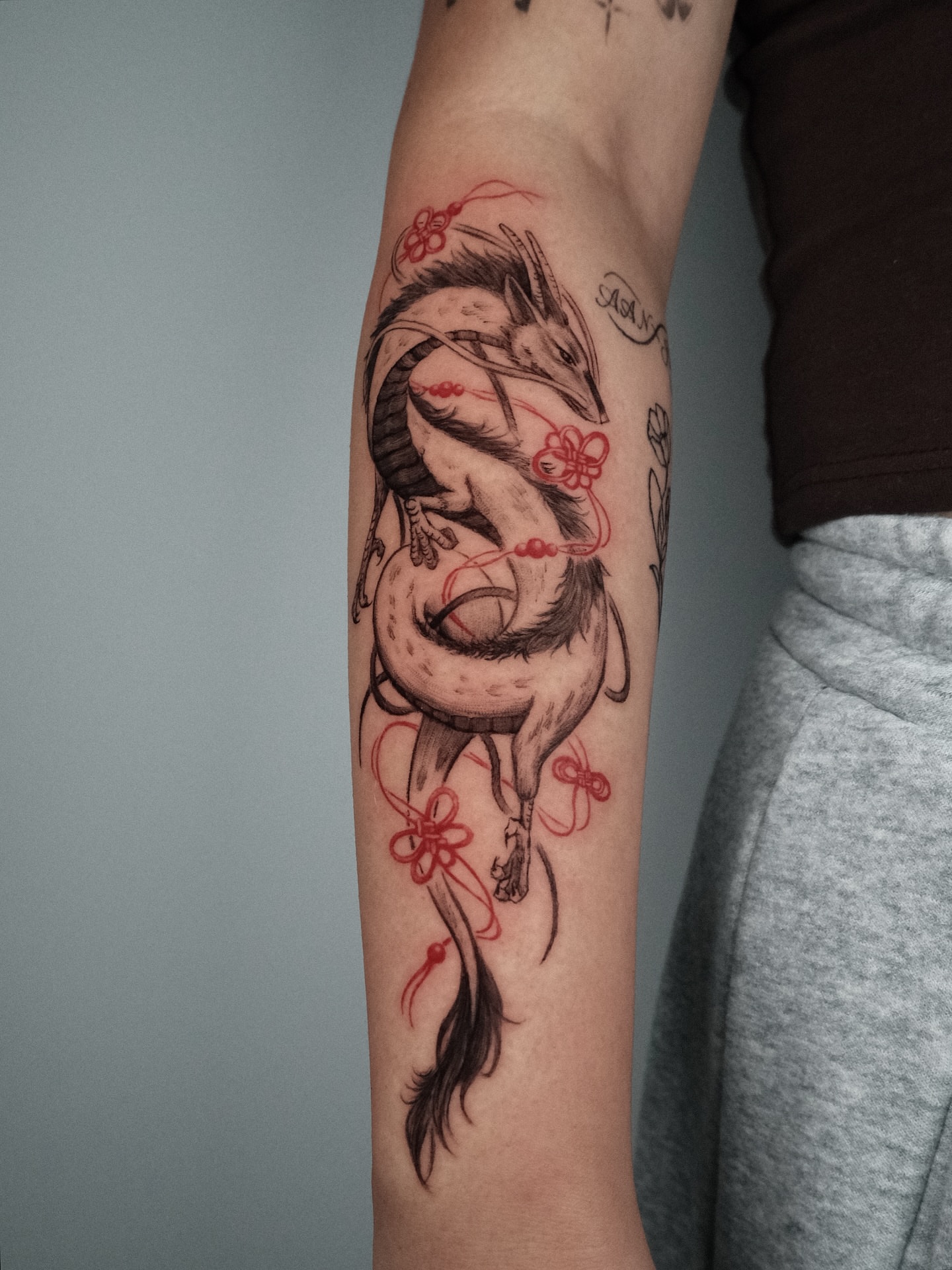 Dragon black and grey tattoo on the forearm by HanaKaki