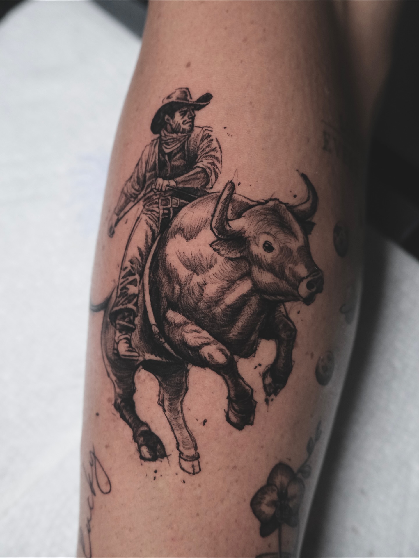 Bull riding black and grey tattoo on the forearm by HanaKaki