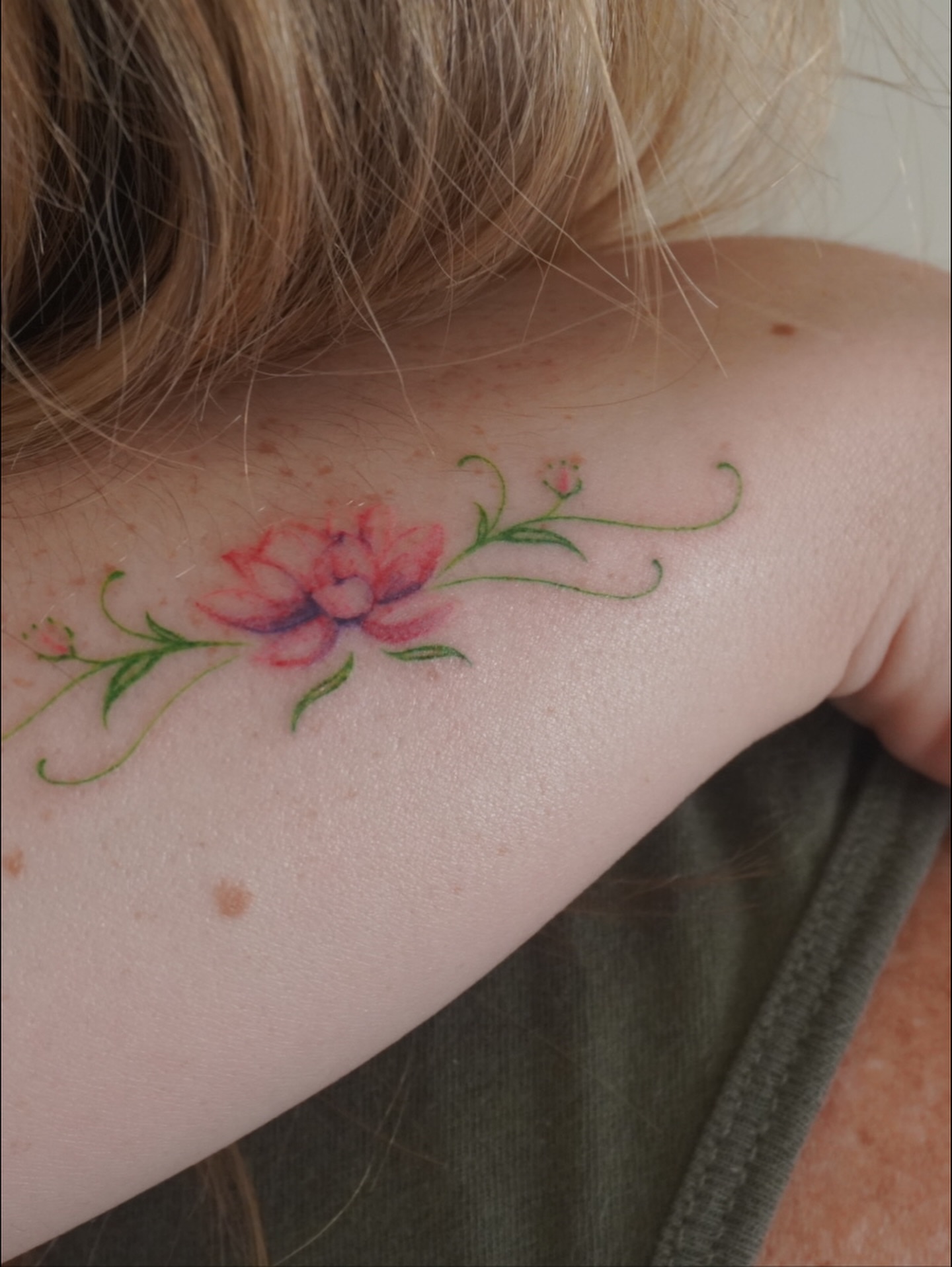 Lotus flower watercolor tattoo on the shoulder by Sun Child Tattoo 🌻