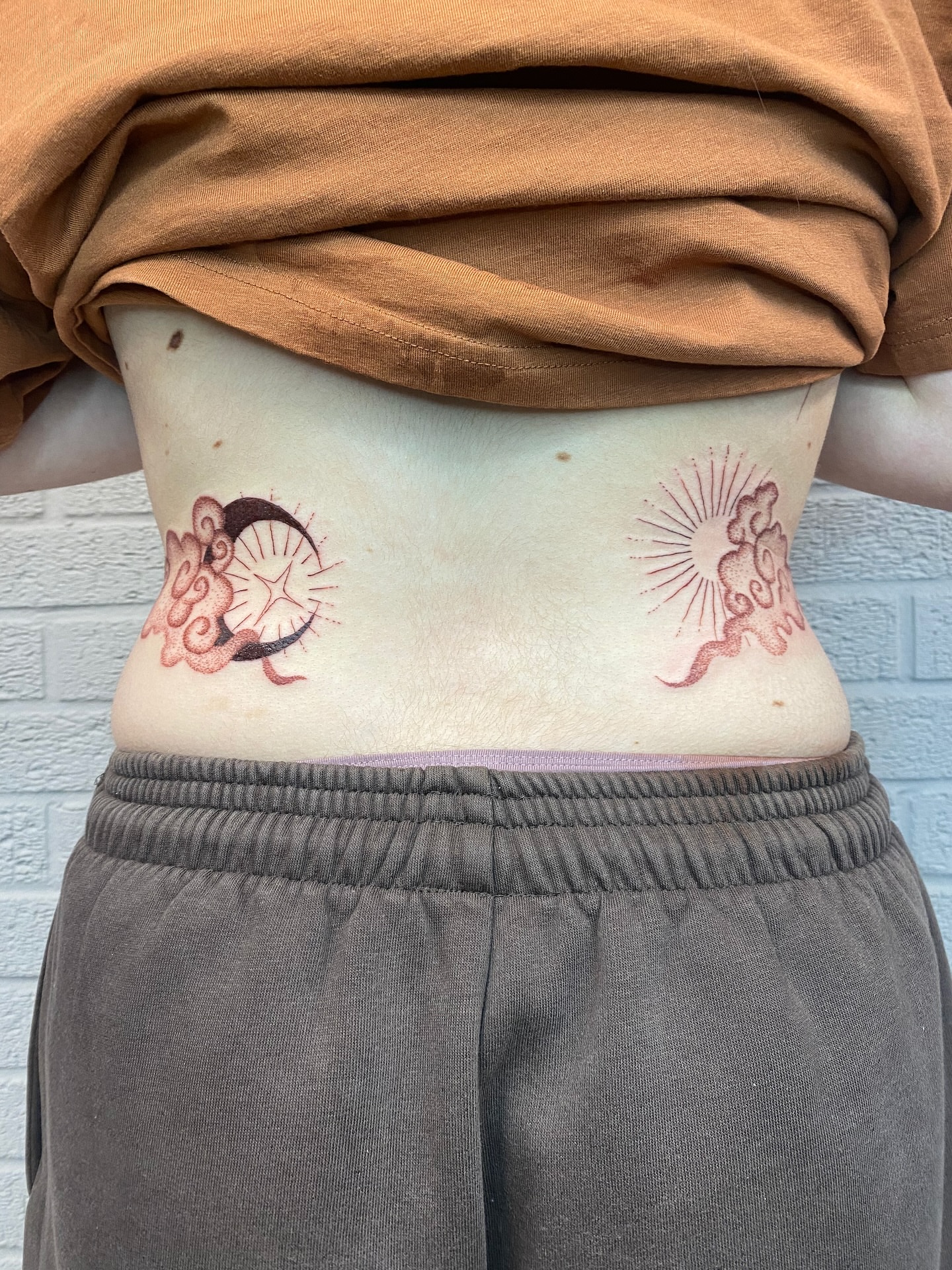 Sun and moon dotwork tattoo on the torso by Ellena Reggiani
