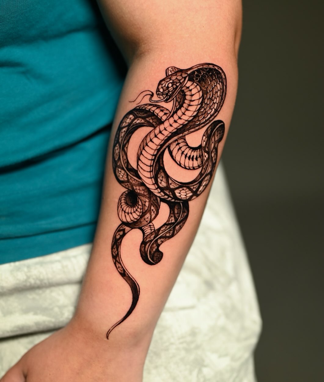 Snake black and grey tattoo on the forearm by Navei