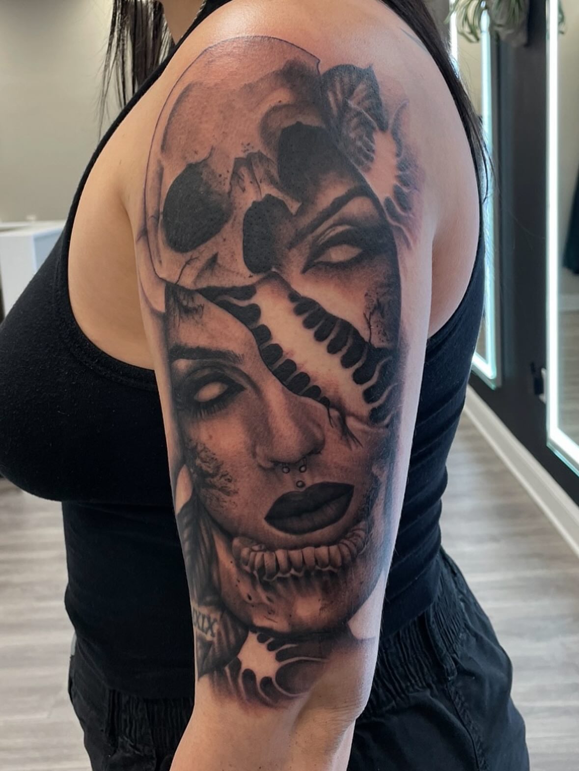 Skull and woman realism tattoo on the shoulder by Robbie Bryant